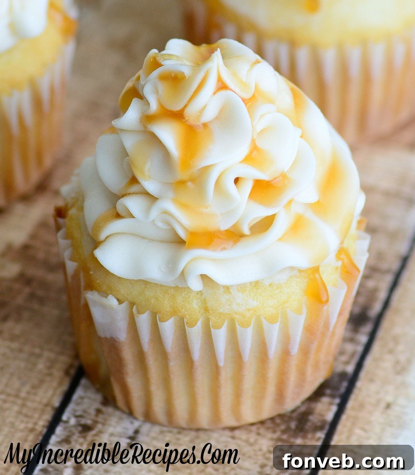 Close-up of a perfectly piped caramel buttercream swirl on a cupcake, with a hint of caramel drizzle.