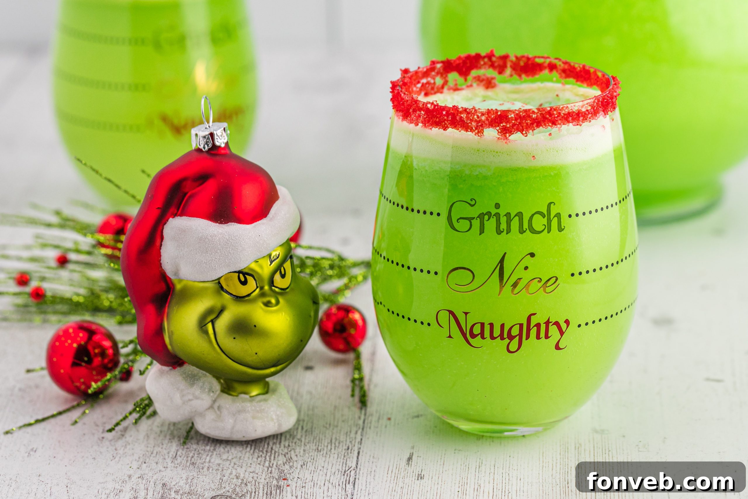 A close-up of Grinch Punch being poured into a glass, showing its vibrant green color and fizz.