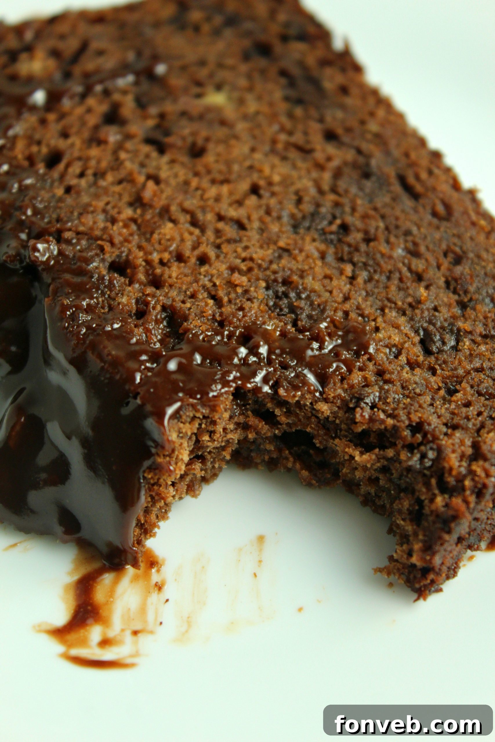 A close-up shot of the top of a Double Chocolate Banana Bread loaf, showing the rich chocolate glaze