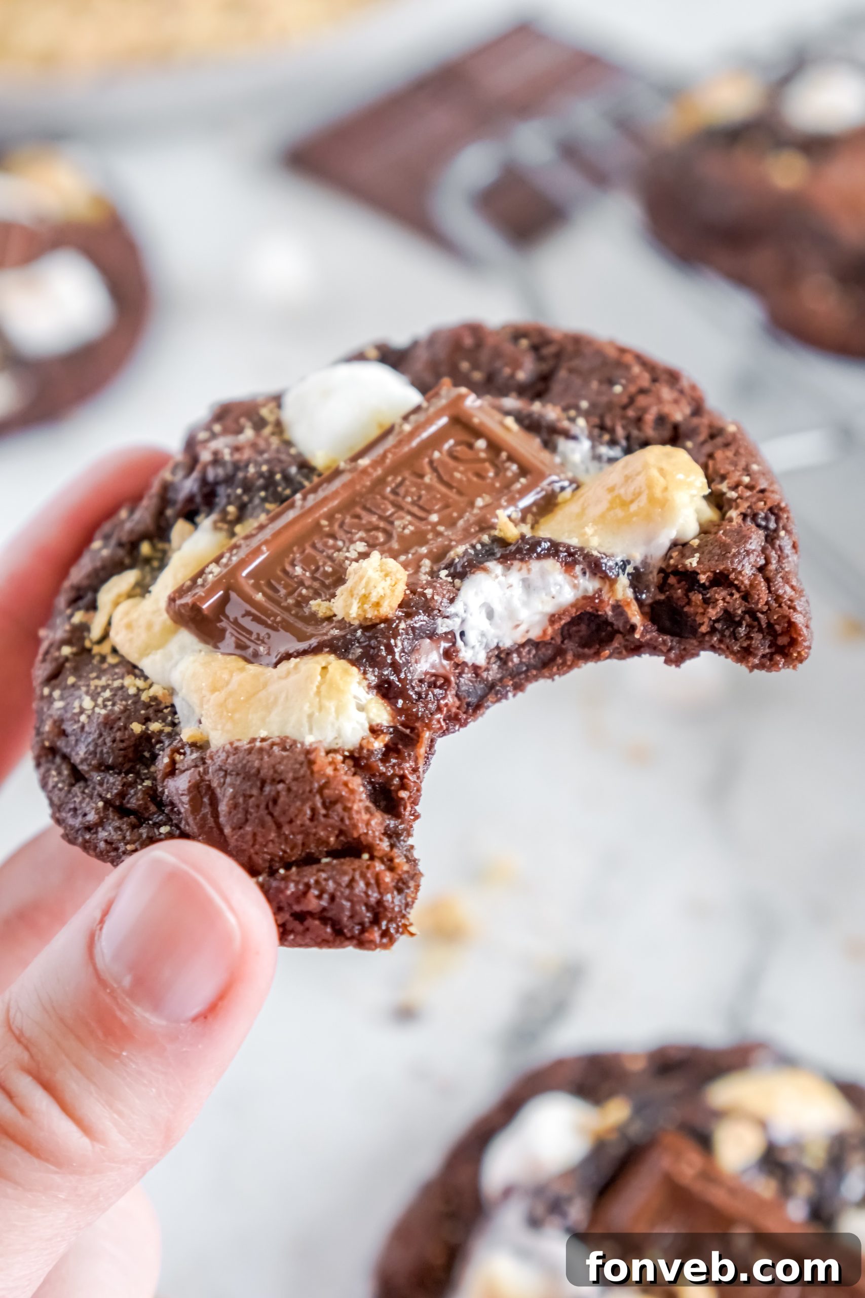Measuring cups and bowls with baking ingredients for Hershey's s'mores cookies
