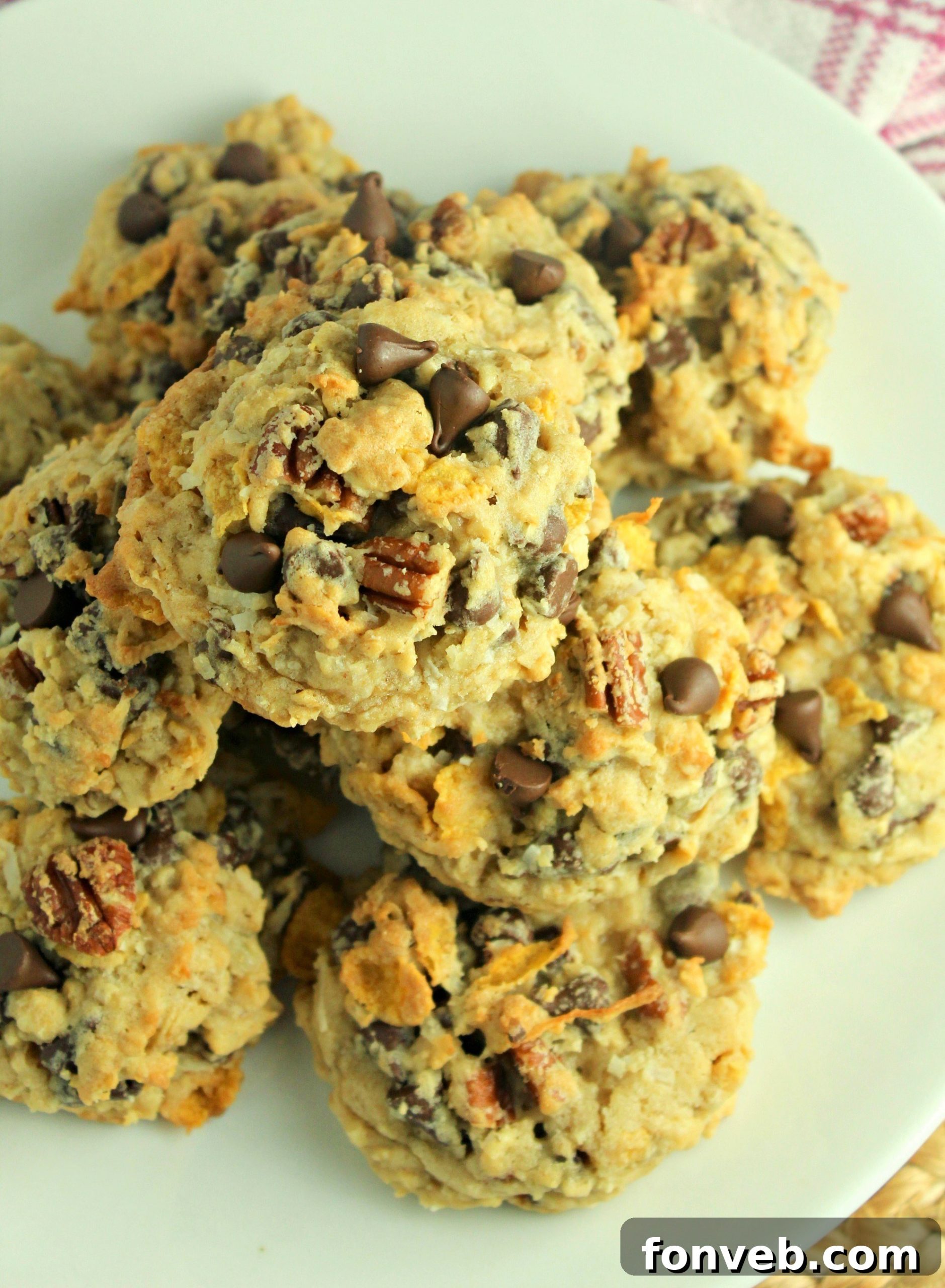Freshly baked Cowboy Cookies neatly stacked in an airtight container for storage.