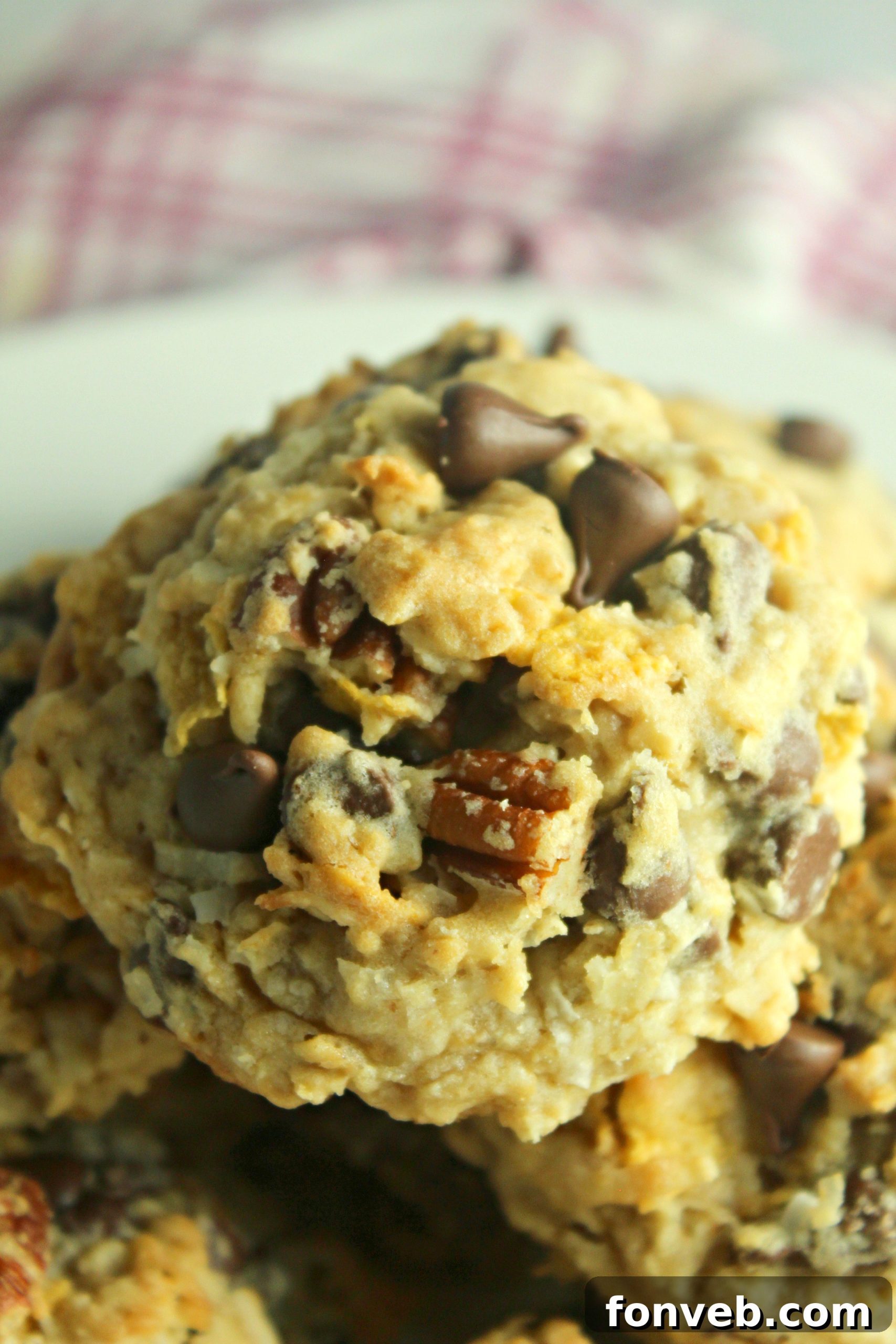 Assortment of ingredients for Cowboy Cookies laid out on a table, including chocolate chips, oats, and pecans.