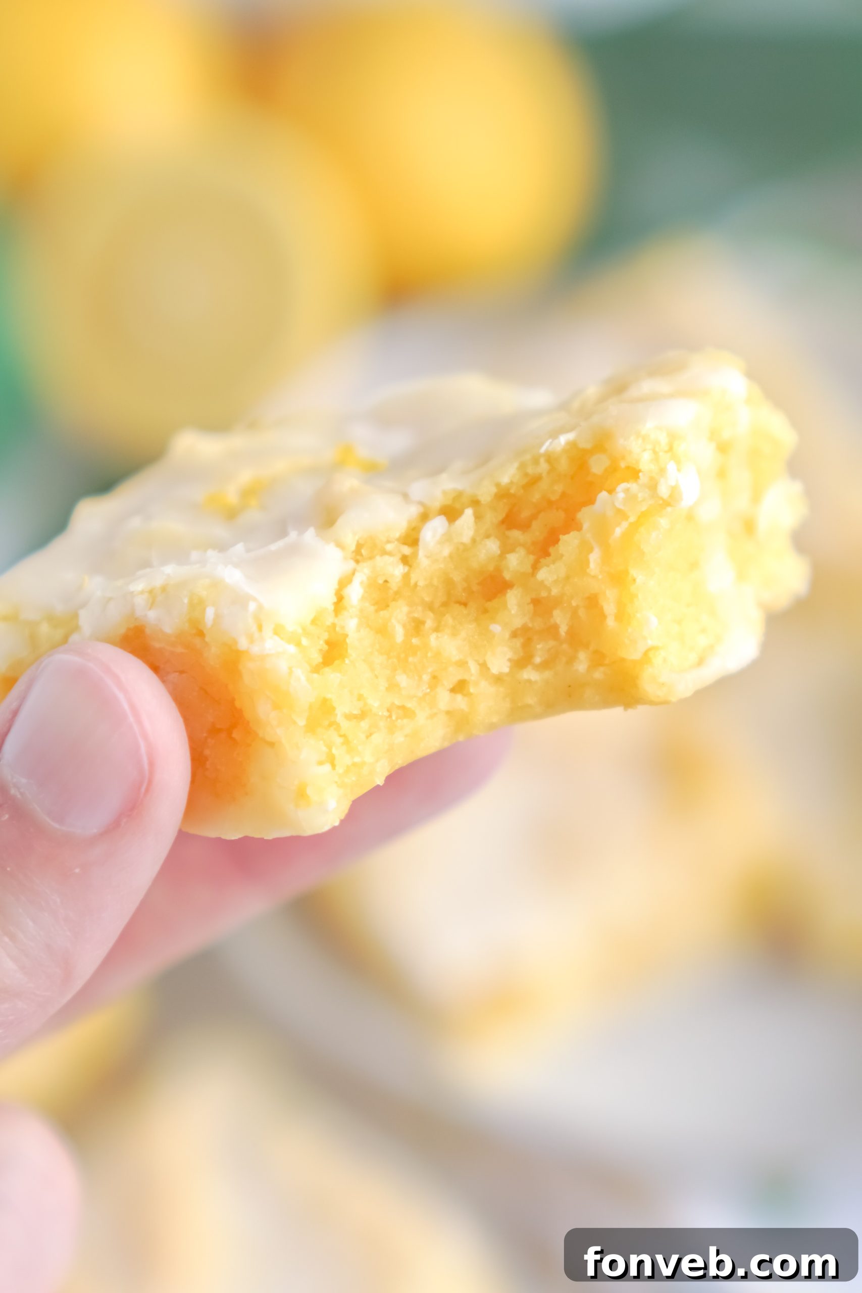 A single lemon brownie, beautifully glazed and perfectly square, photographed from a close-up angle.