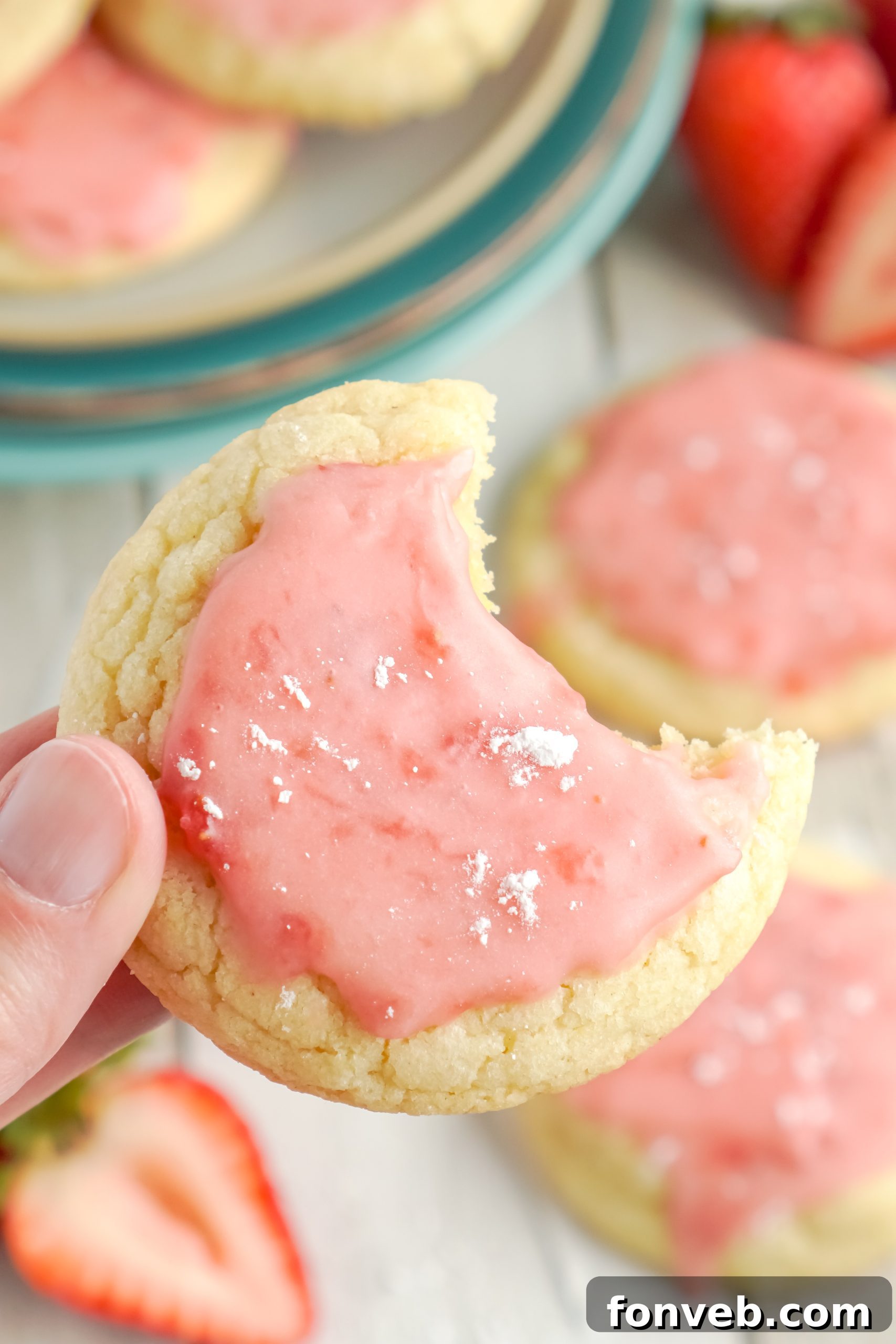 A beautifully decorated plate of strawberry glazed sugar cookies, ready to be served.