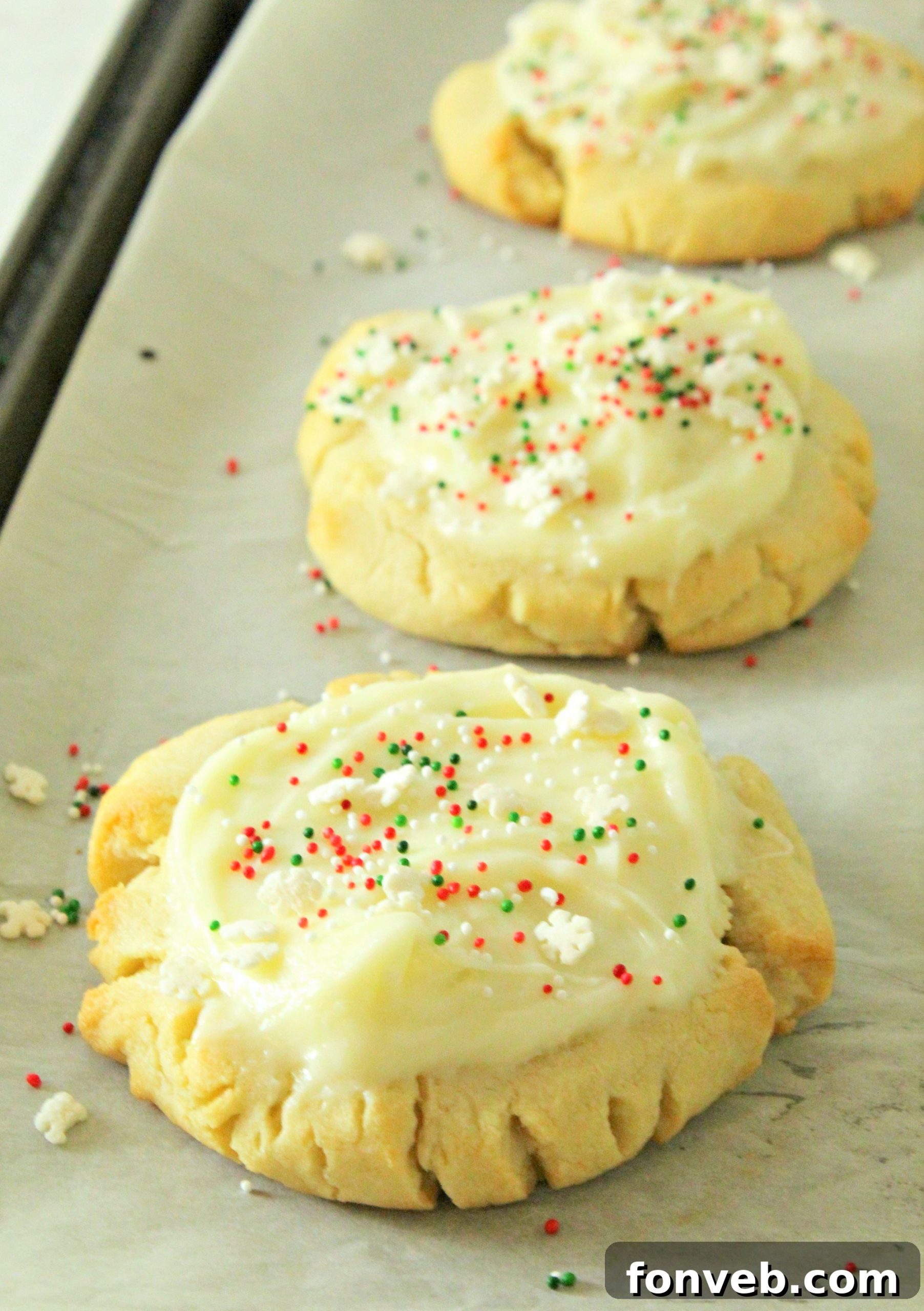 Close-up of Swig Sugar Cookies decorated with light pink frosting, showing their soft, crinkled edges.