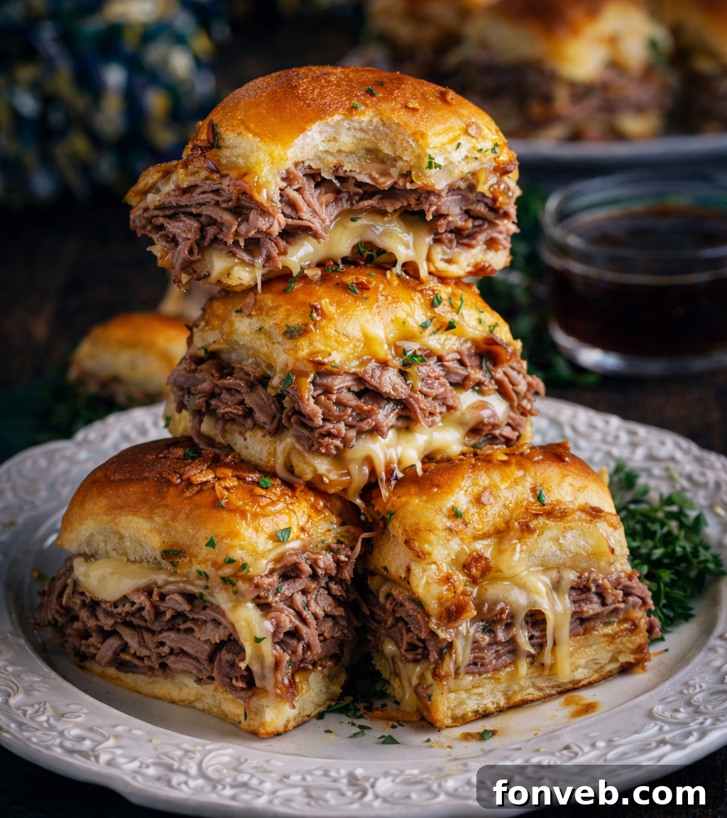 Dunkable French Dip Sliders 2 french dip sliders stacked on a white plate