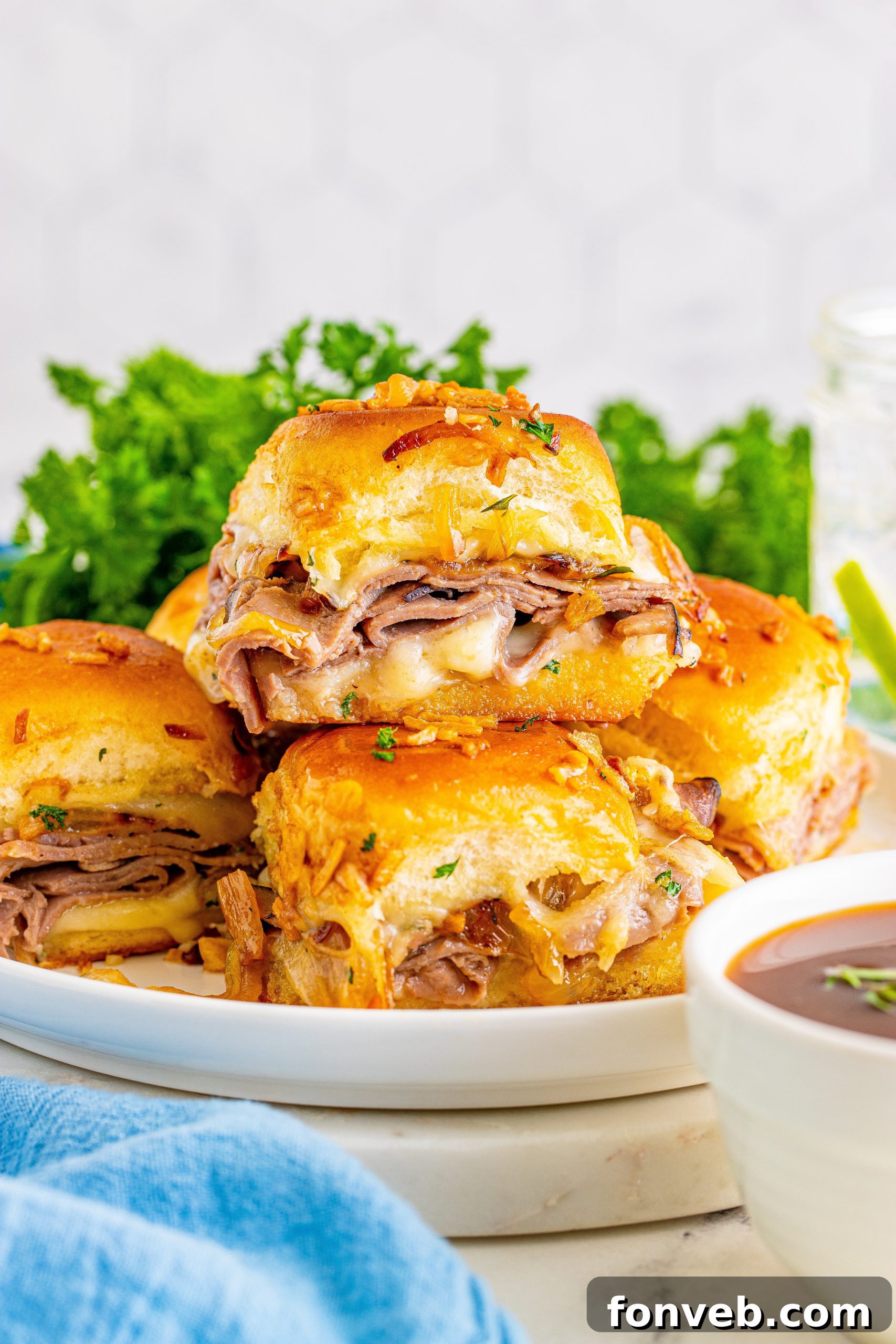 Dunkable French Dip Sliders 13 French Dip Sliders on a white plate