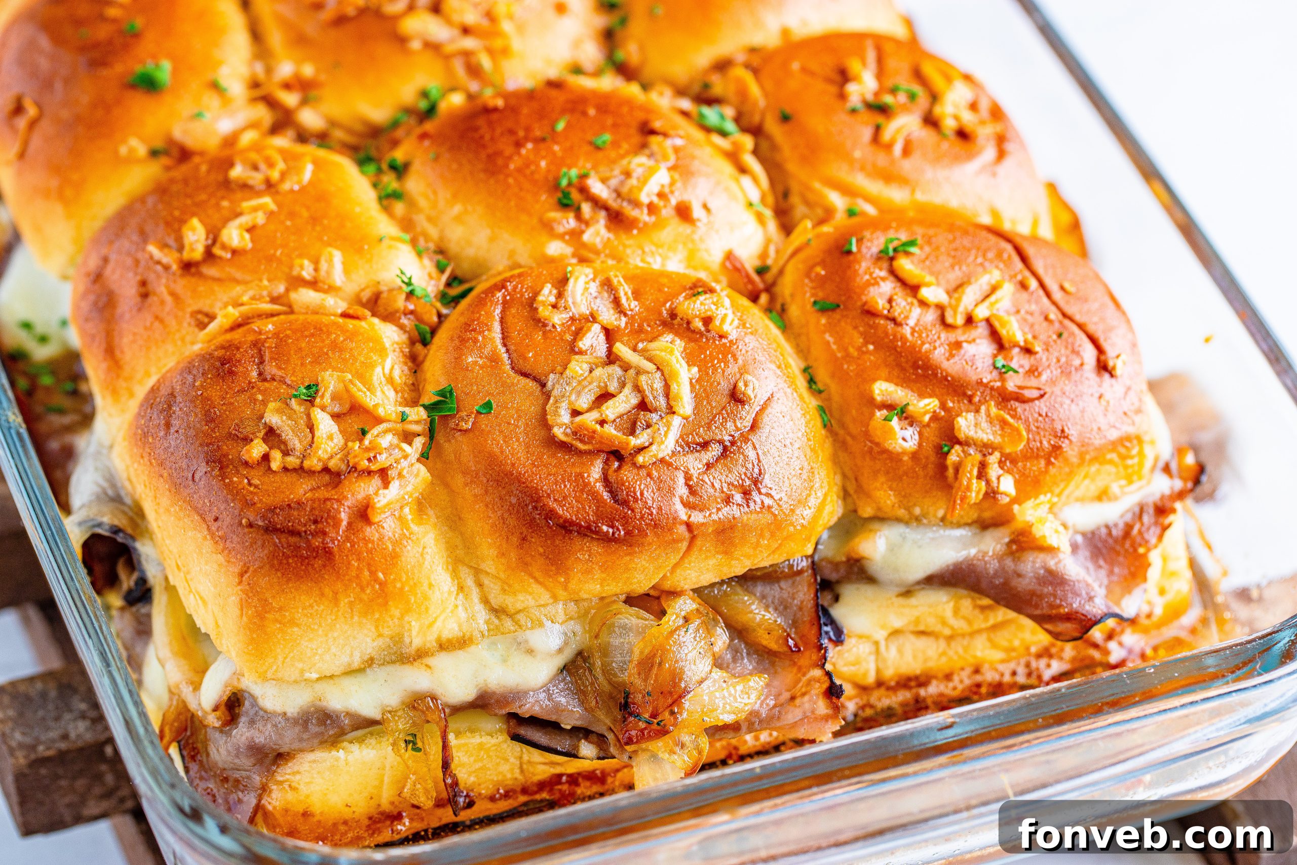 Dunkable French Dip Sliders 7 French Dip Sliders uncut in the baking dish with caramelized onions on top