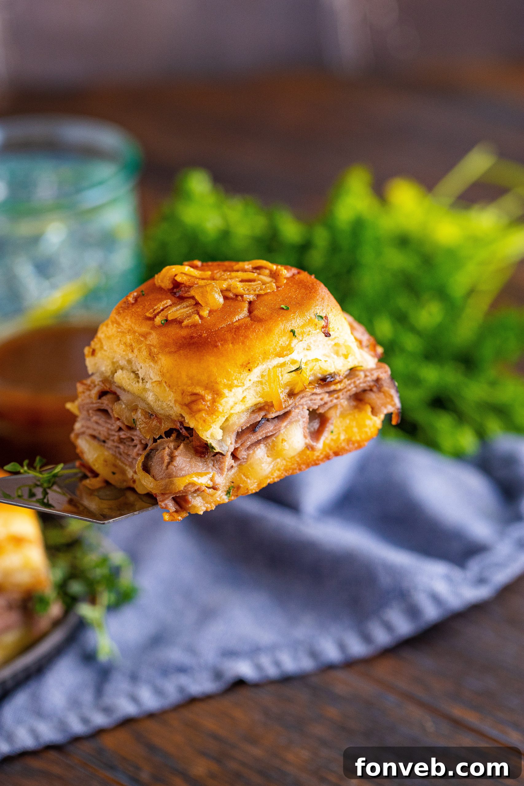 Dunkable French Dip Sliders 10 French Dip Slider being lifted on a spatula