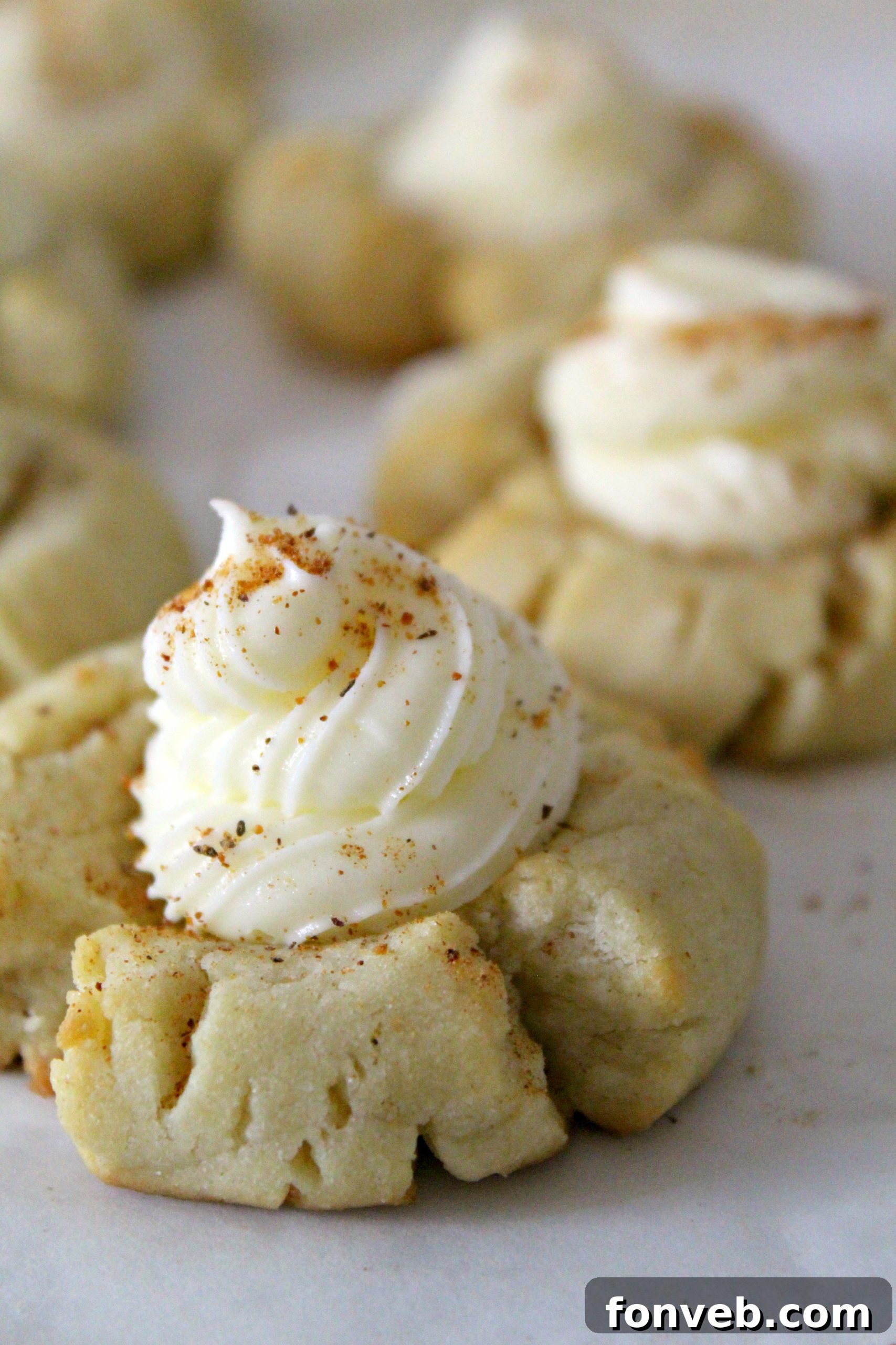 Close-up of Eggnog Thumbprint Cookies cooling on a wire rack, ready for frosting.