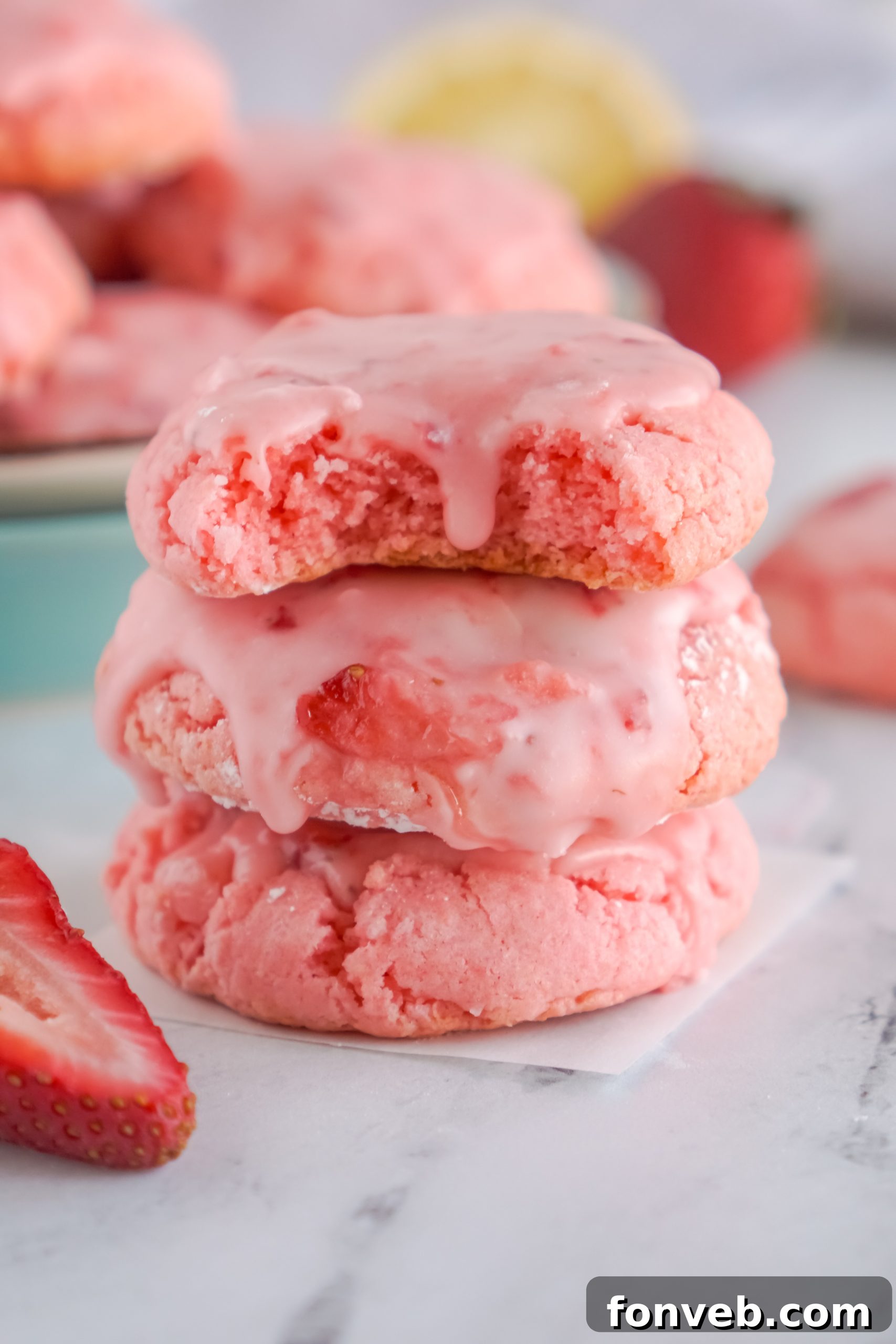 Close-up of freshly baked Strawberry Cake Mix Cookies with a vibrant pink glaze.