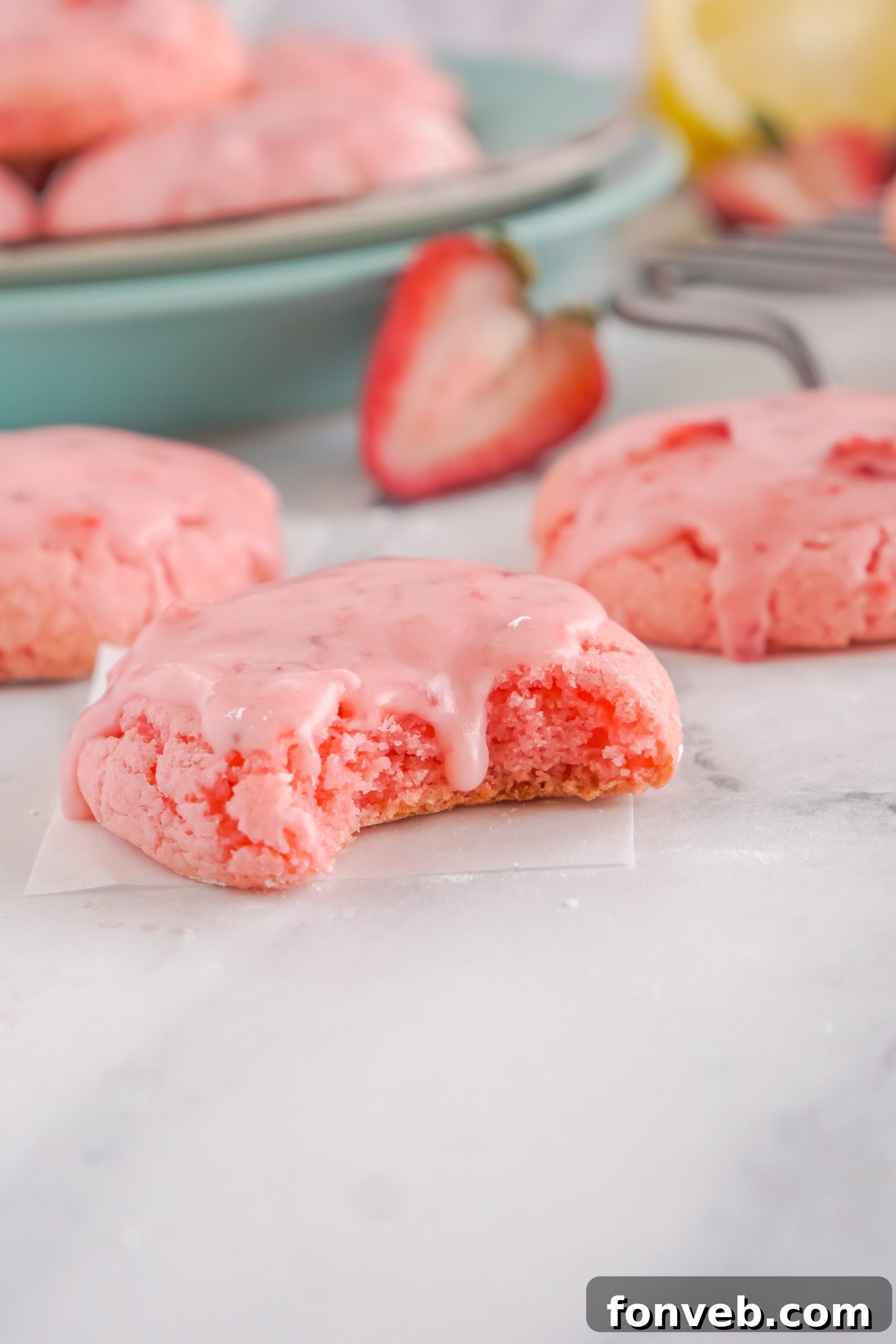 Stack of strawberry cookies on a small dessert stand, ready for serving.