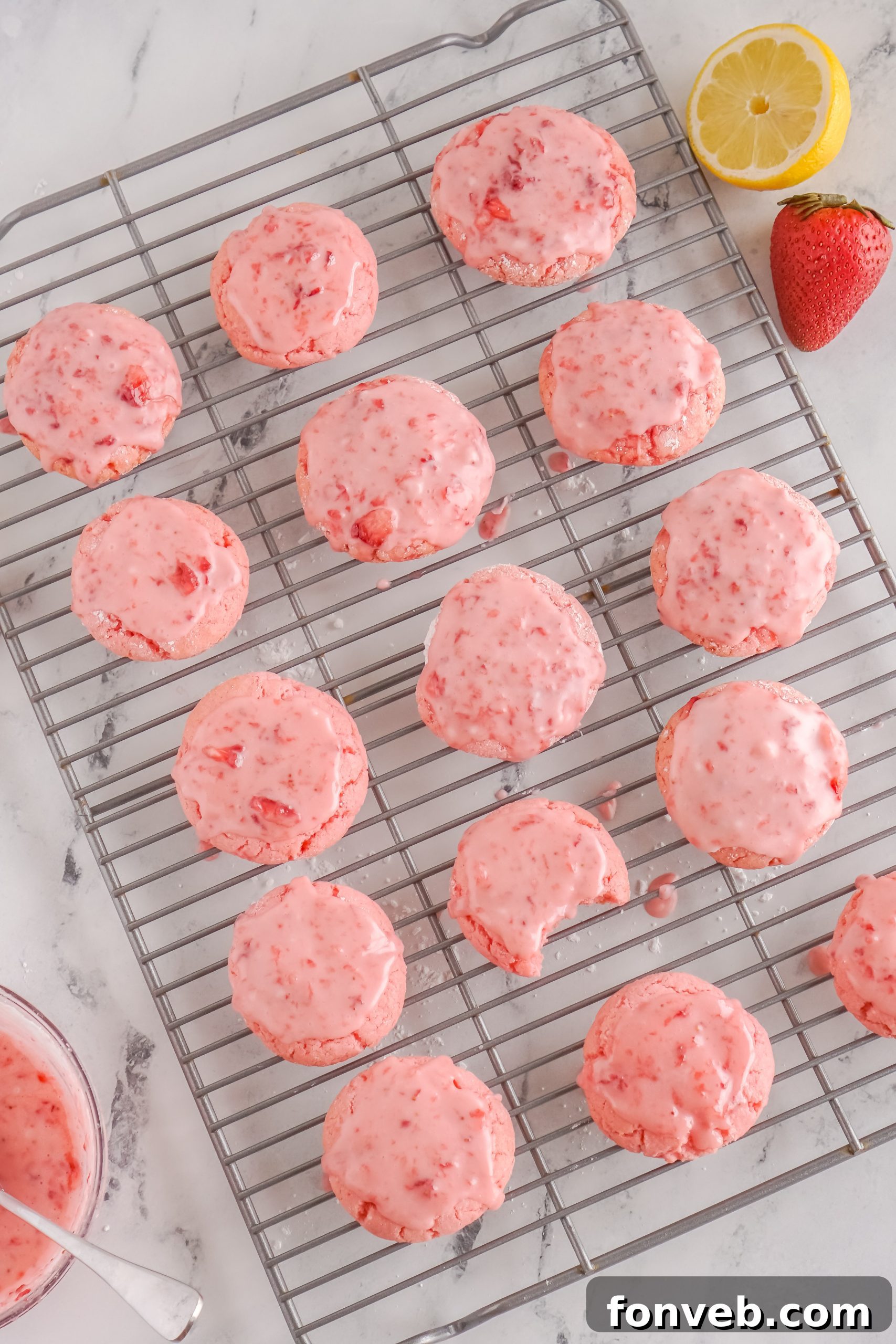 A plate of glazed strawberry cookies, ready to be served and enjoyed.