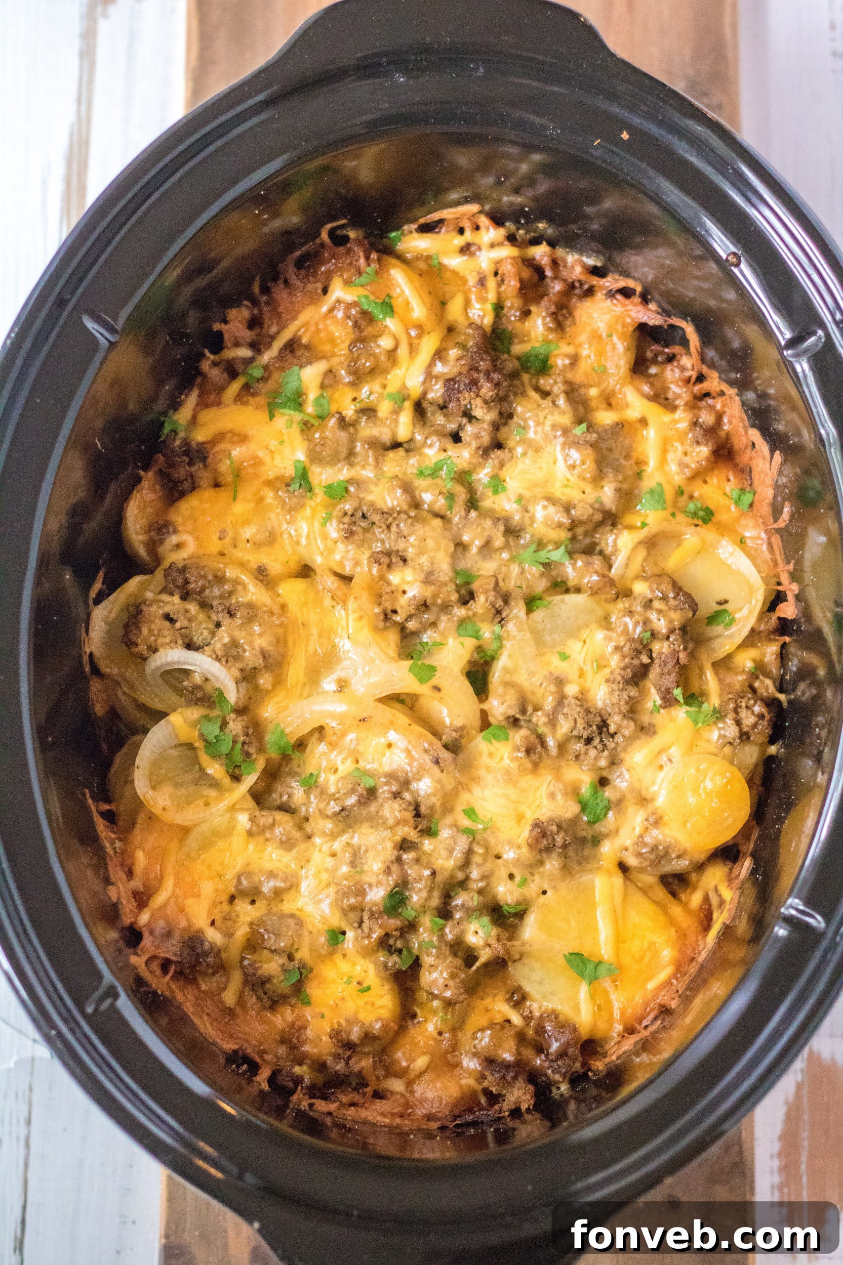 Delicious Slow Cooker Beef and Potato Au Gratin served in a large slow cooker pot, ready to be enjoyed.
