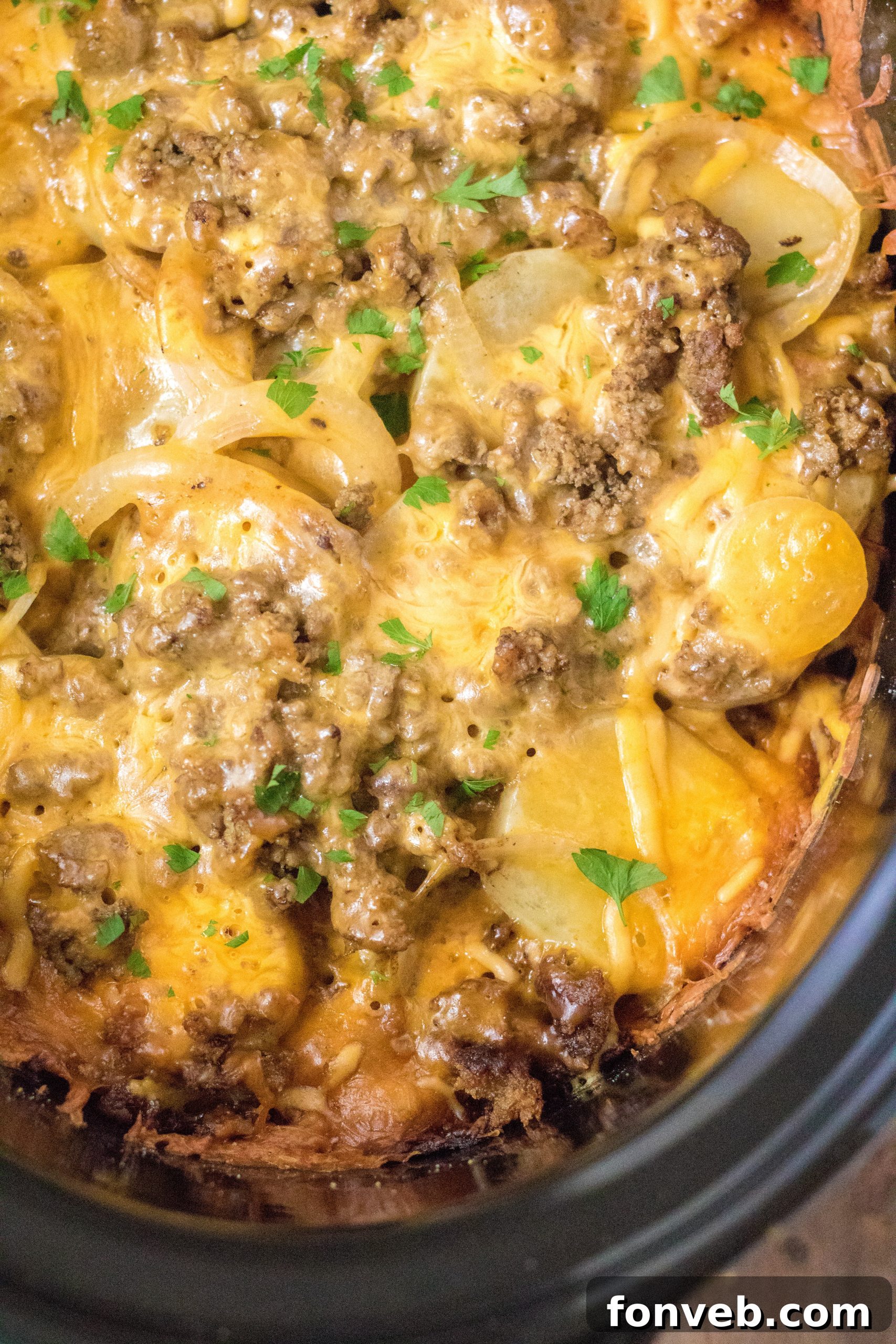 A cooked portion of Slow Cooker Beef and Potato Au Gratin, garnished with fresh herbs.