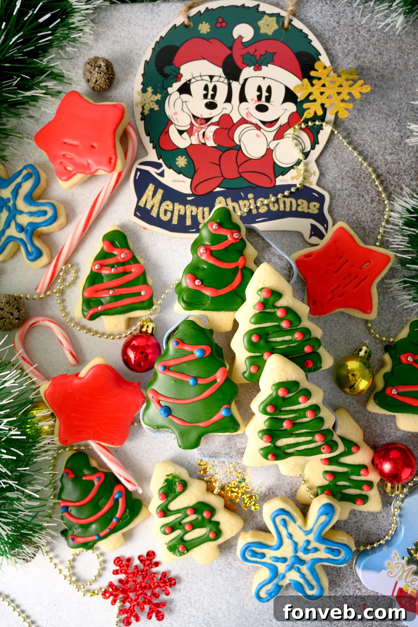 Sugar cookie dough rolled out and being cut into heart shapes with cookie cutters.