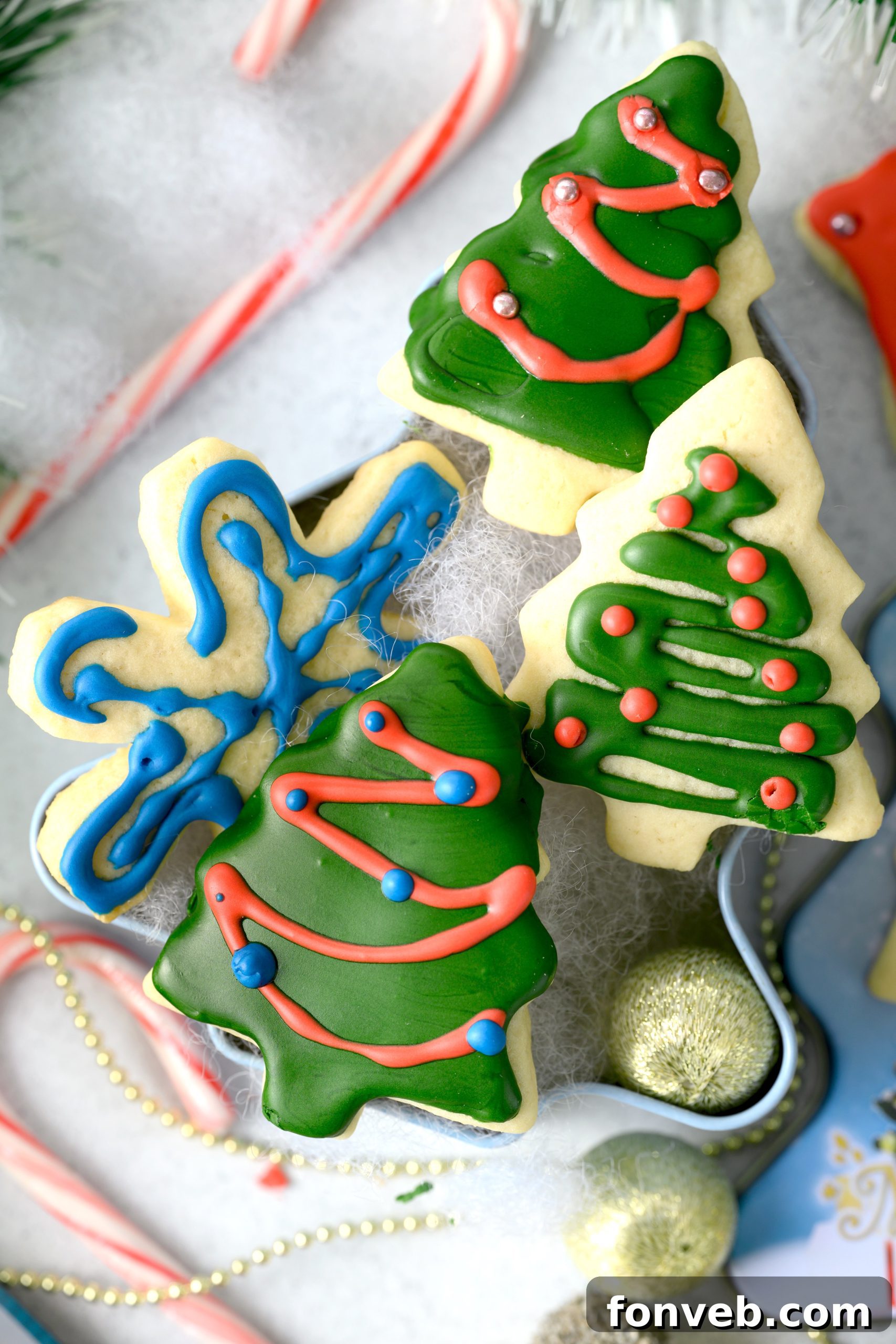 A baker using a hand mixer to cream butter and sugar in a bowl.