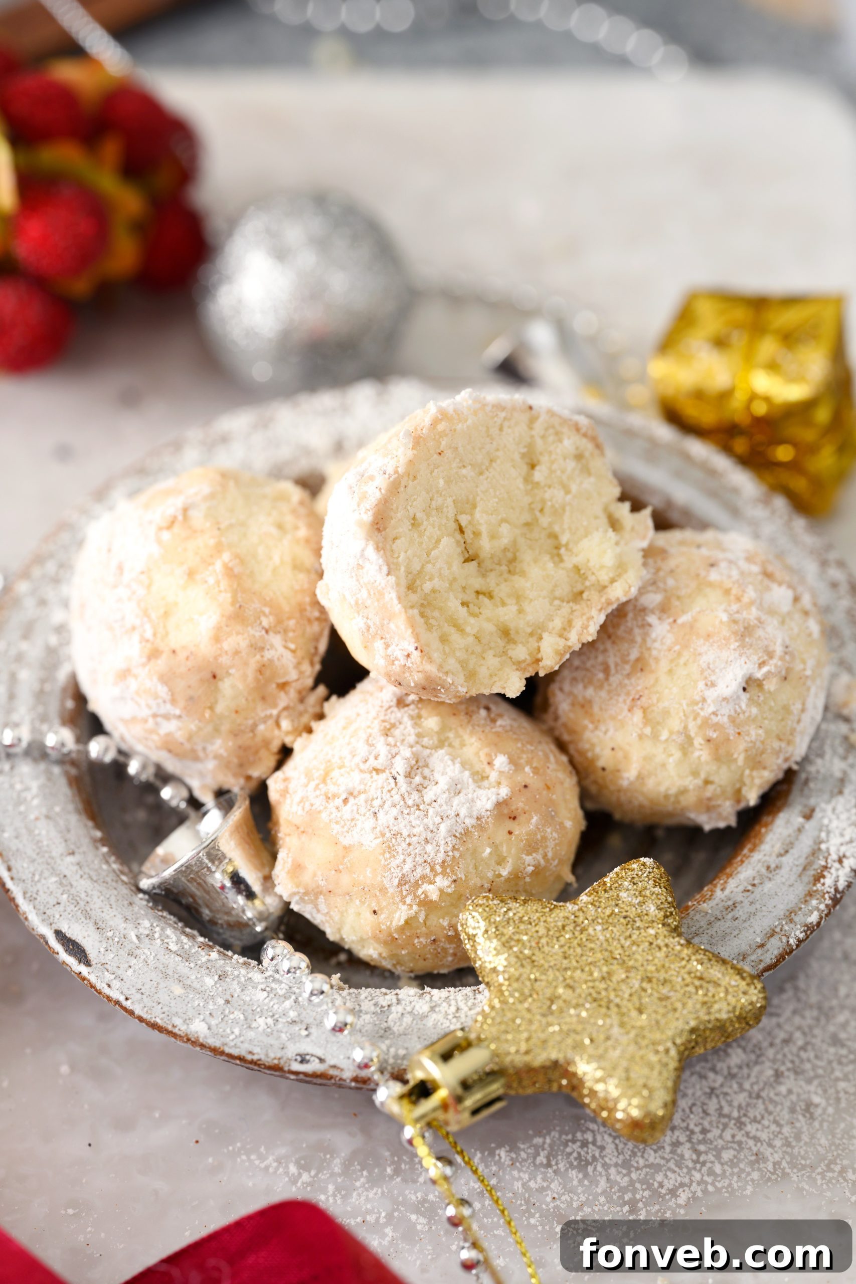 A festive arrangement of Cinnamon Mexican Wedding Cookies on a wooden board