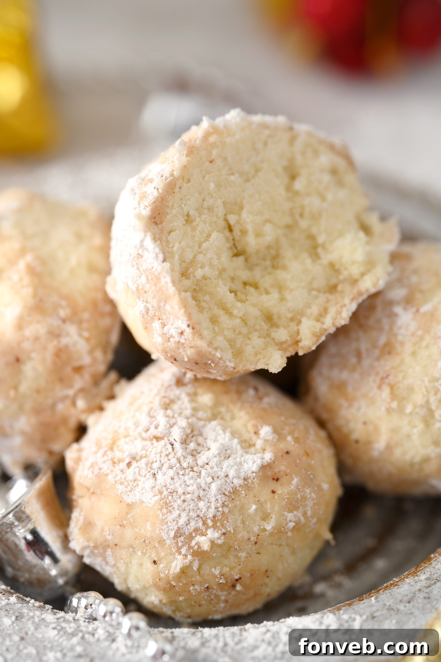 A close-up of a single Cinnamon Mexican Wedding Cookie, perfectly coated