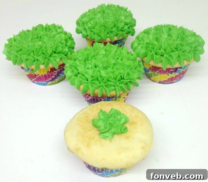 Close-up of a bunny butt cupcake with green frosting, chocolate wafer, and decorative bunny feet.