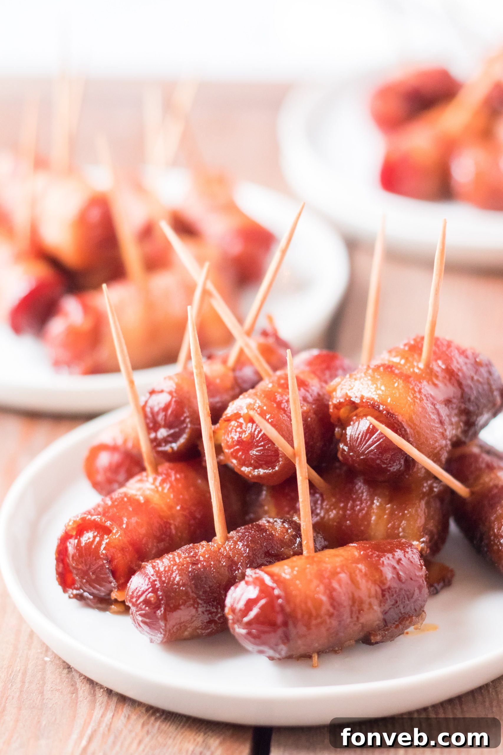 Delicious Slow Cooker Bacon Wrapped Smokies piled high in a bowl, ready to serve.