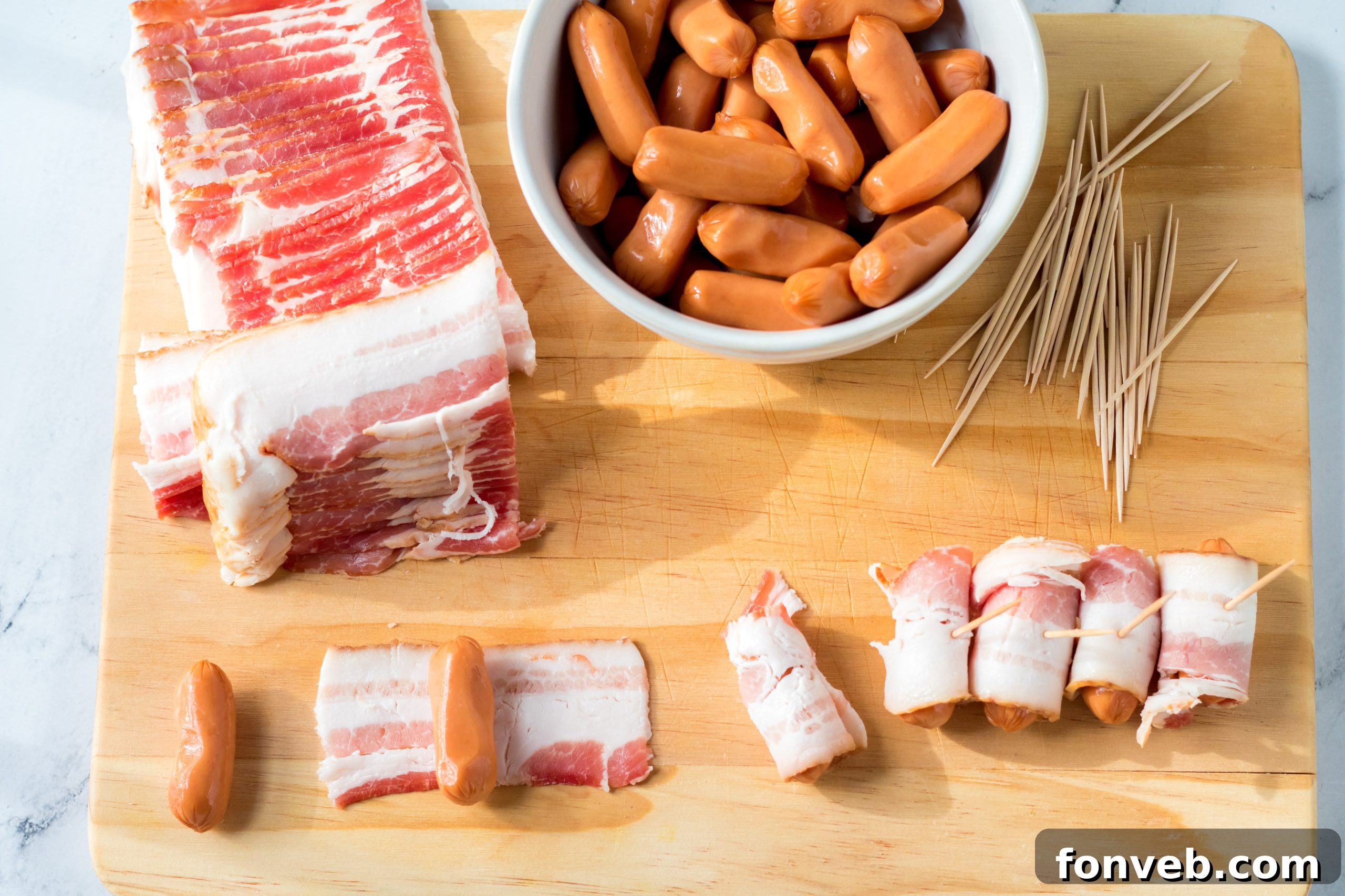 Close-up of golden brown Slow Cooker Bacon Wrapped Smokies, glistening with a sweet glaze.