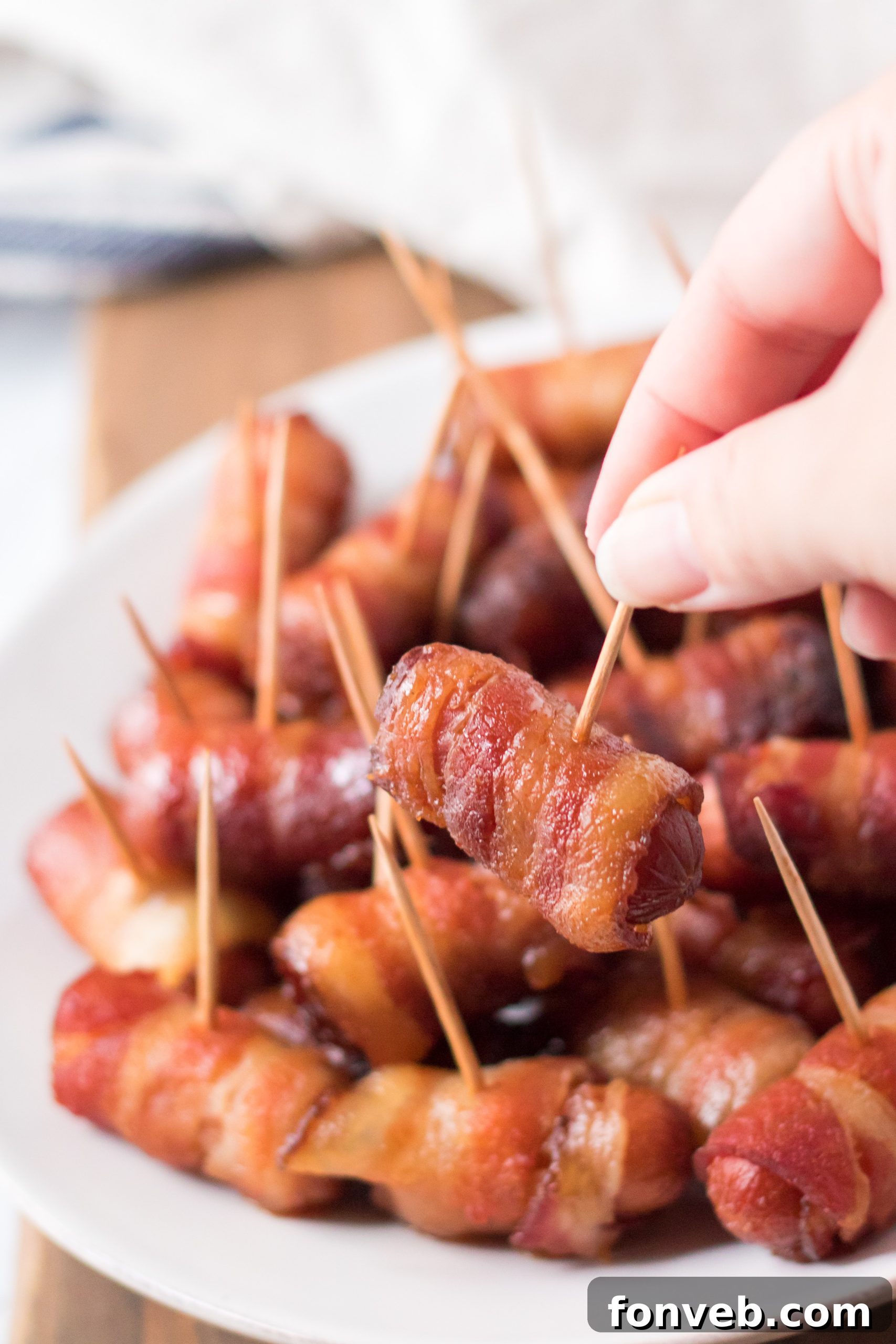 A bowl of Slow Cooker Bacon Wrapped Smokies, emphasizing their readiness for a party.