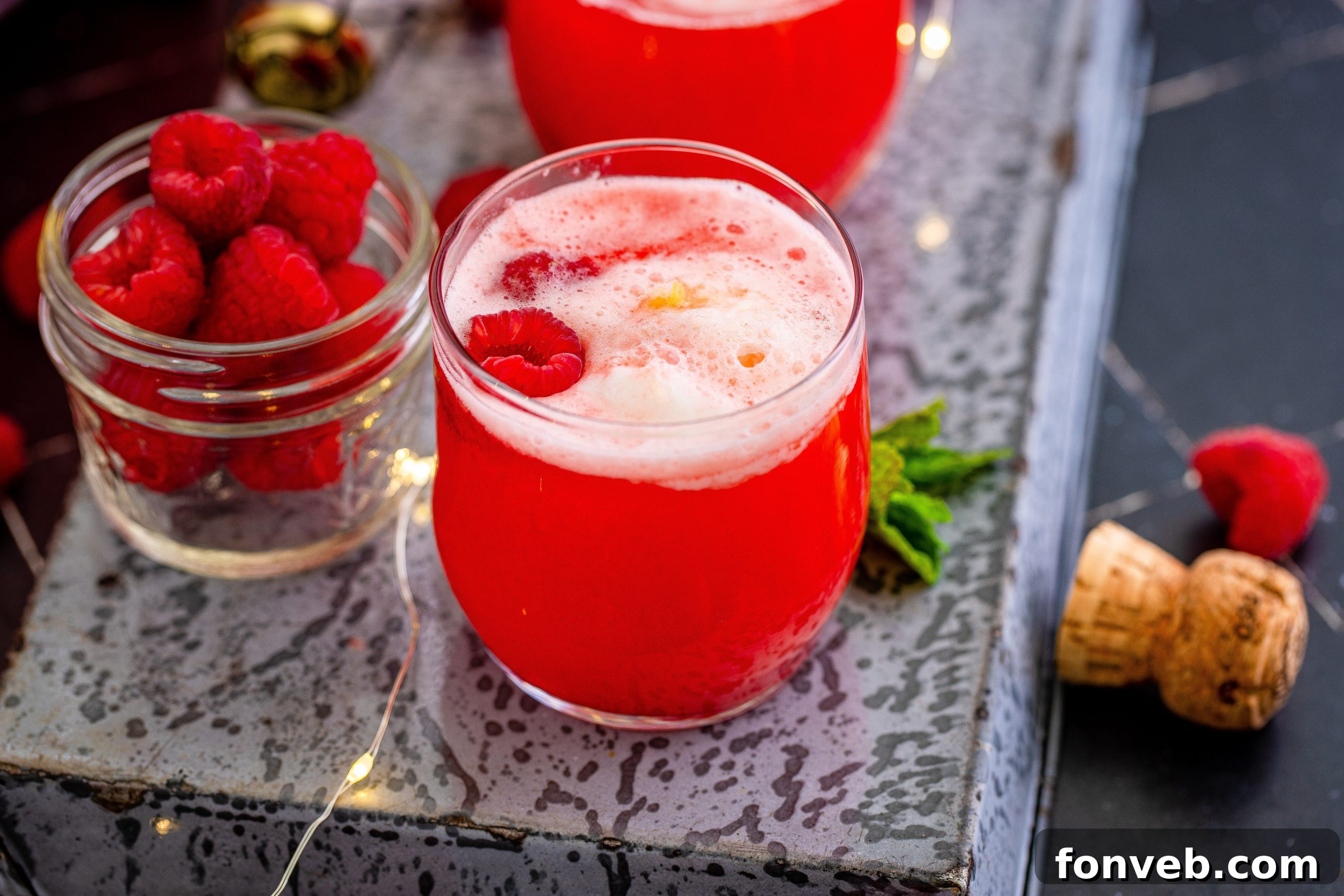A close-up of the boozy sherbet punch in a glass, showing the creamy texture and vibrant color.