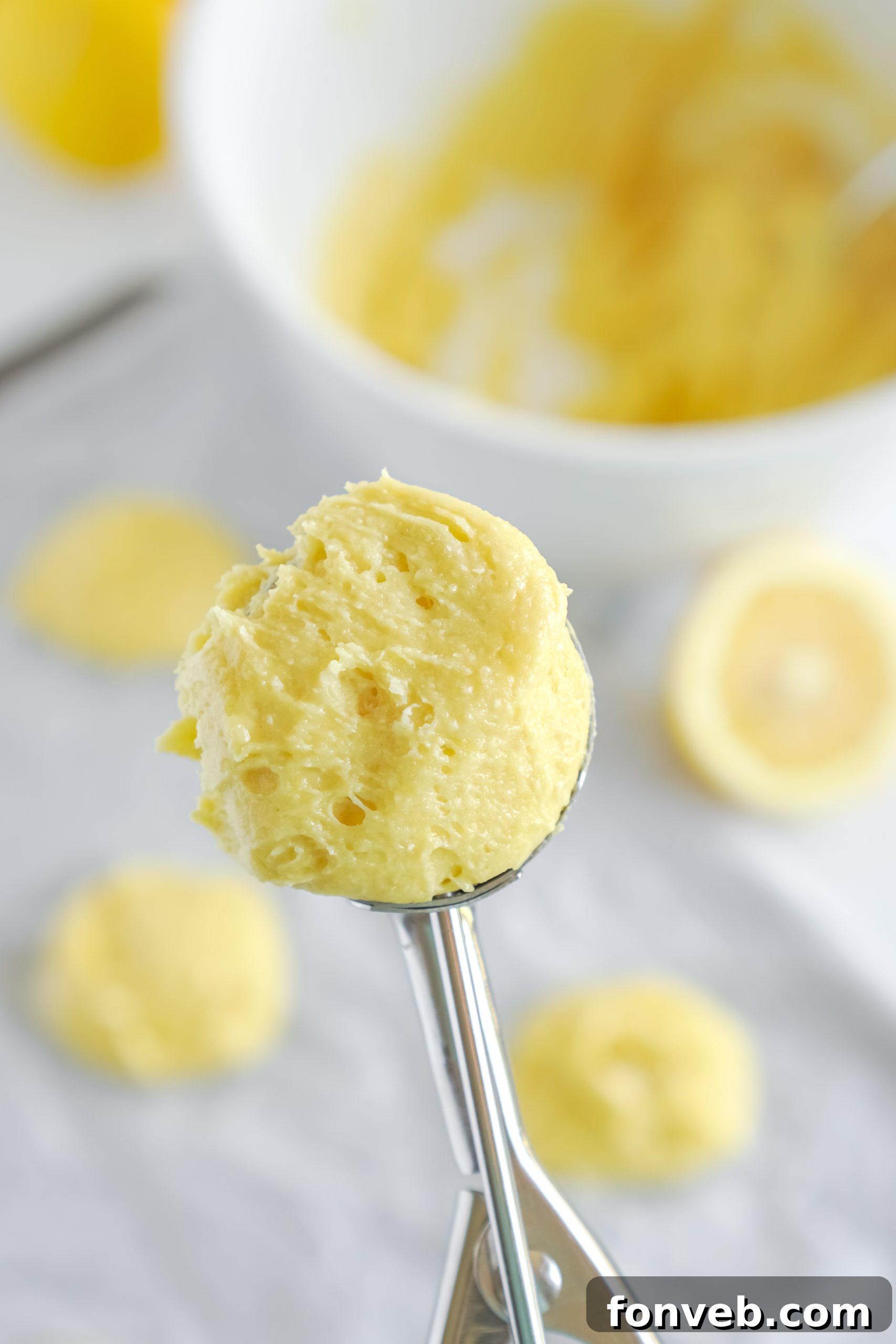 A charming plate of freshly baked lemon cake mix cookies, some gleaming with glaze and others plain, ready to be enjoyed.