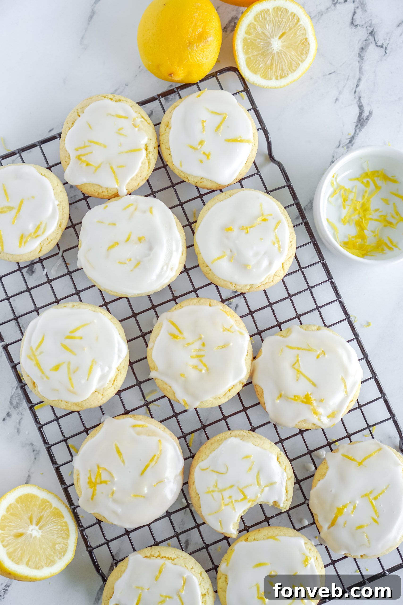 An array of delicate lemon cake mix cookies, artfully arranged on a rustic wooden board, emphasizing their perfectly baked, soft texture.