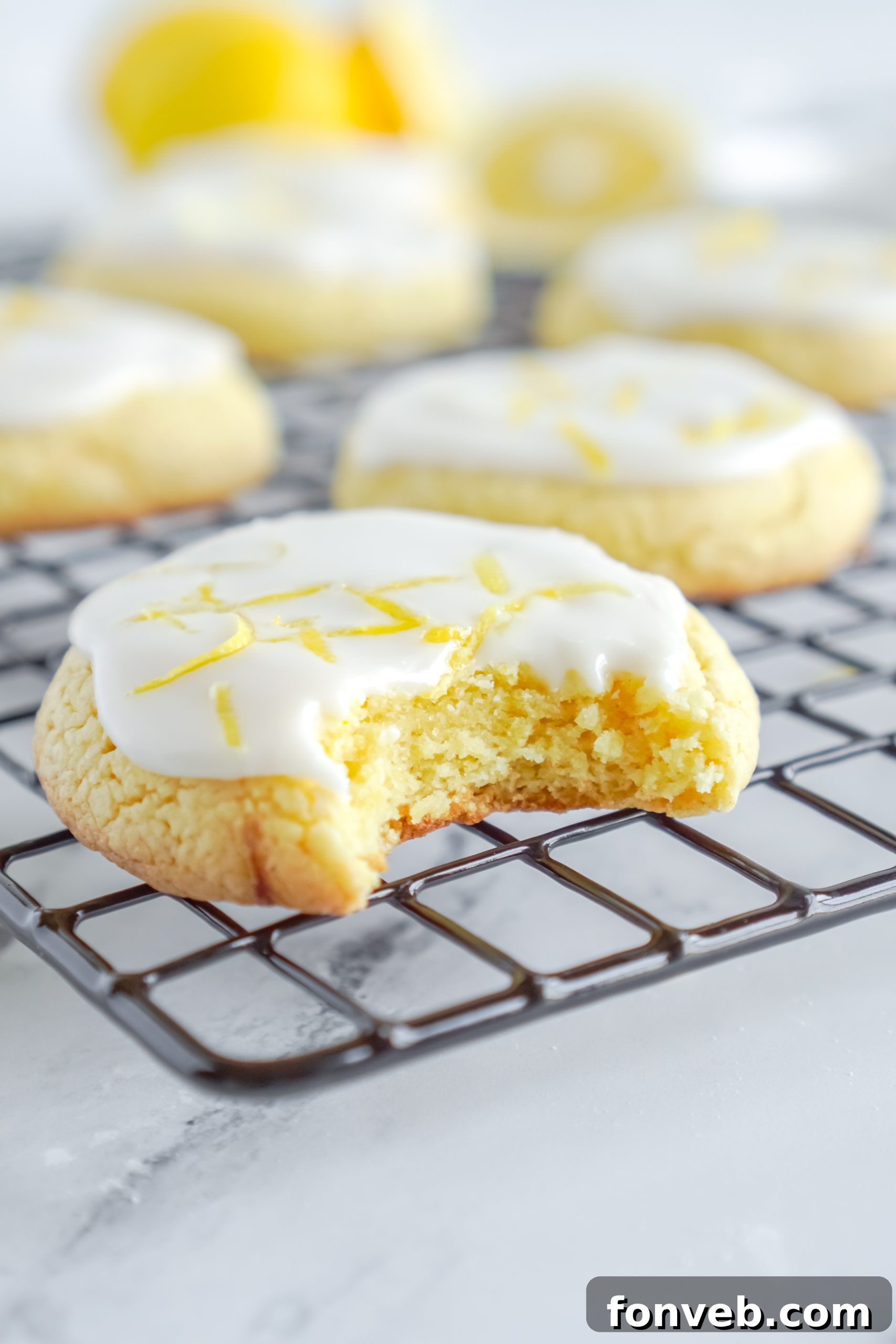 A delightful spread of various lemon cake mix cookies, some plain and some elegantly glazed, arranged on a charming rustic surface.