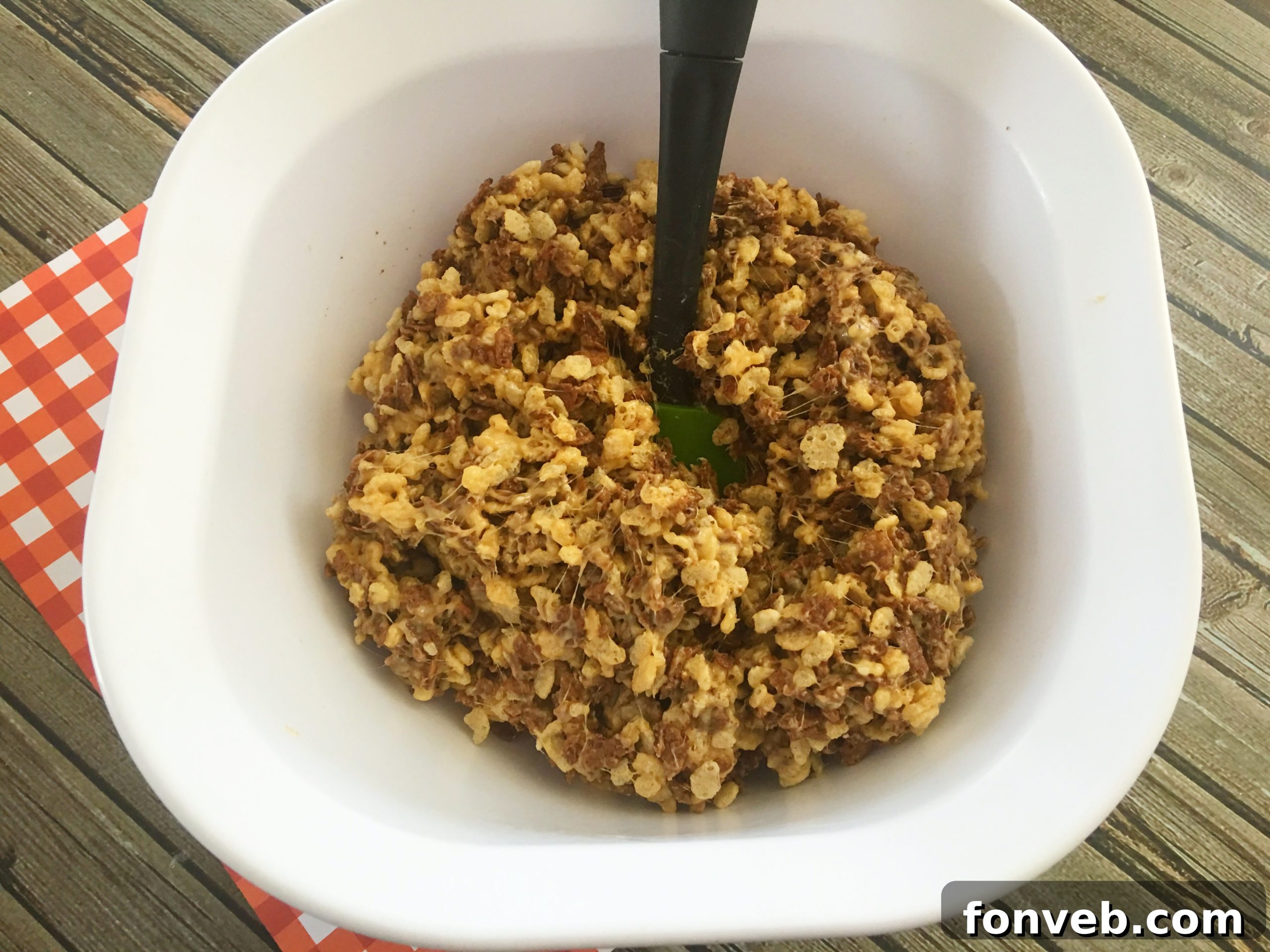 A tray of Reese's Rice Krispies Treats being pressed into shape