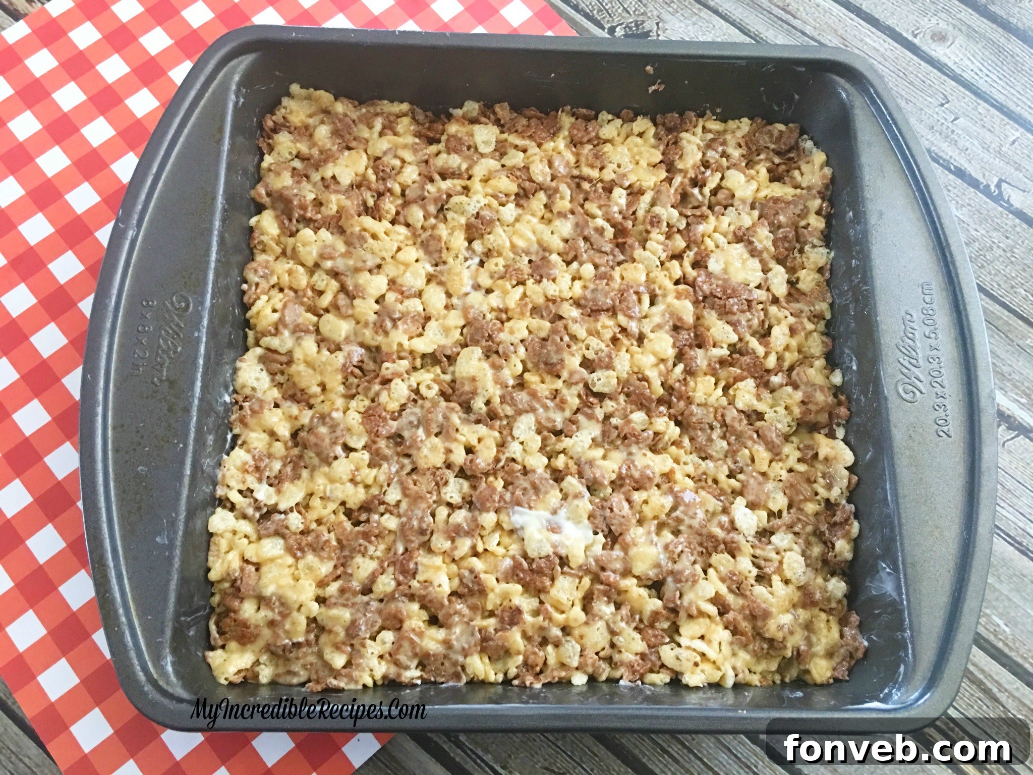 Reese's Rice Krispies Treats with a generous chocolate and peanut butter drizzle