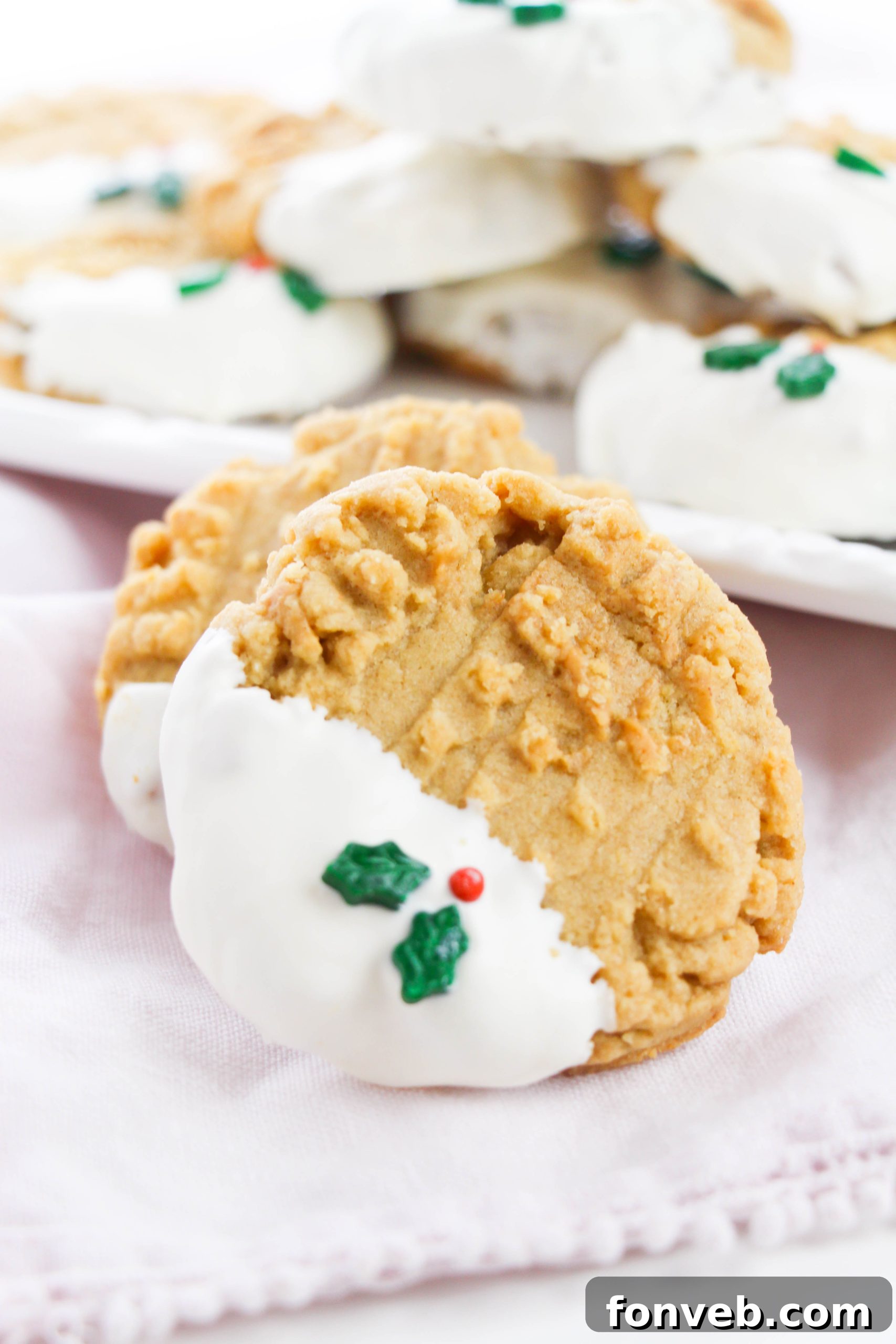 Several white chocolate dipped peanut butter cookies neatly arranged on a cooling rack, showcasing their criss-cross pattern