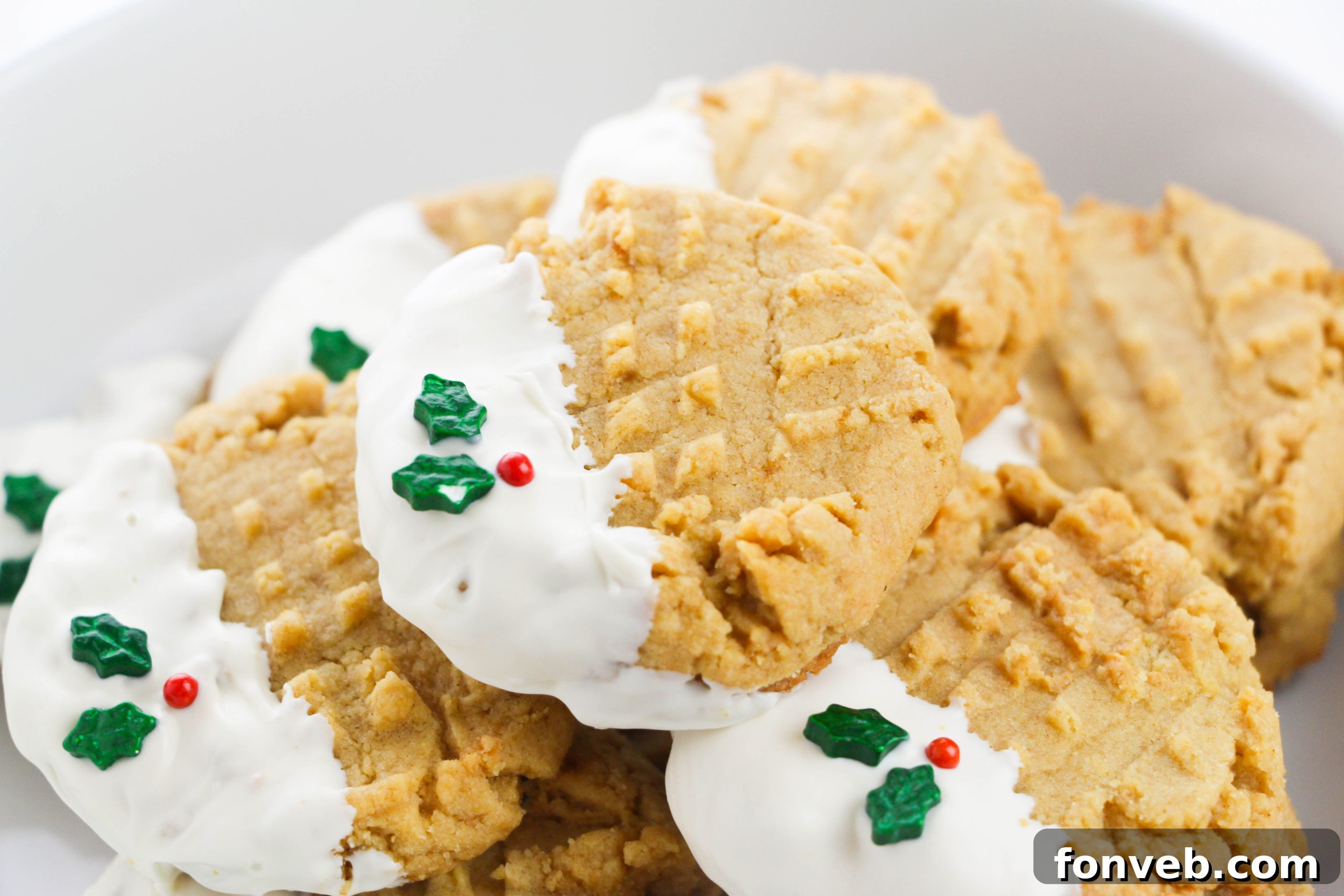A serving platter featuring both plain and white chocolate dipped peanut butter cookies, some with sprinkles