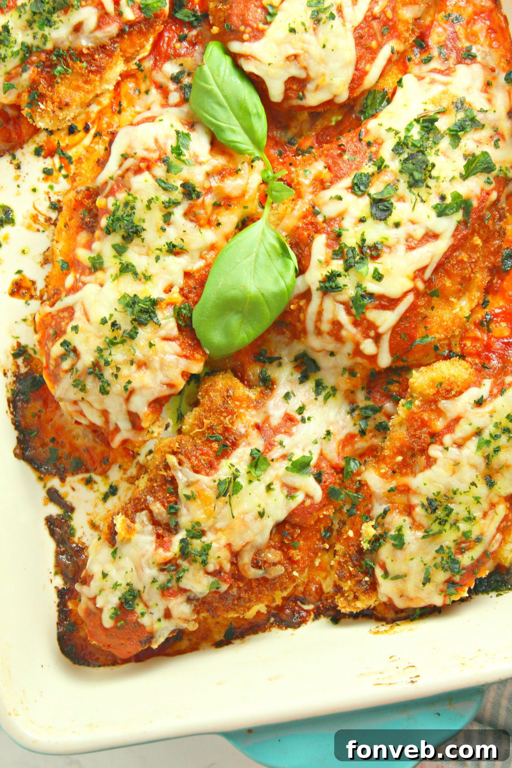 Close-up of freshly cooked Chicken Parmesan with melted cheese.