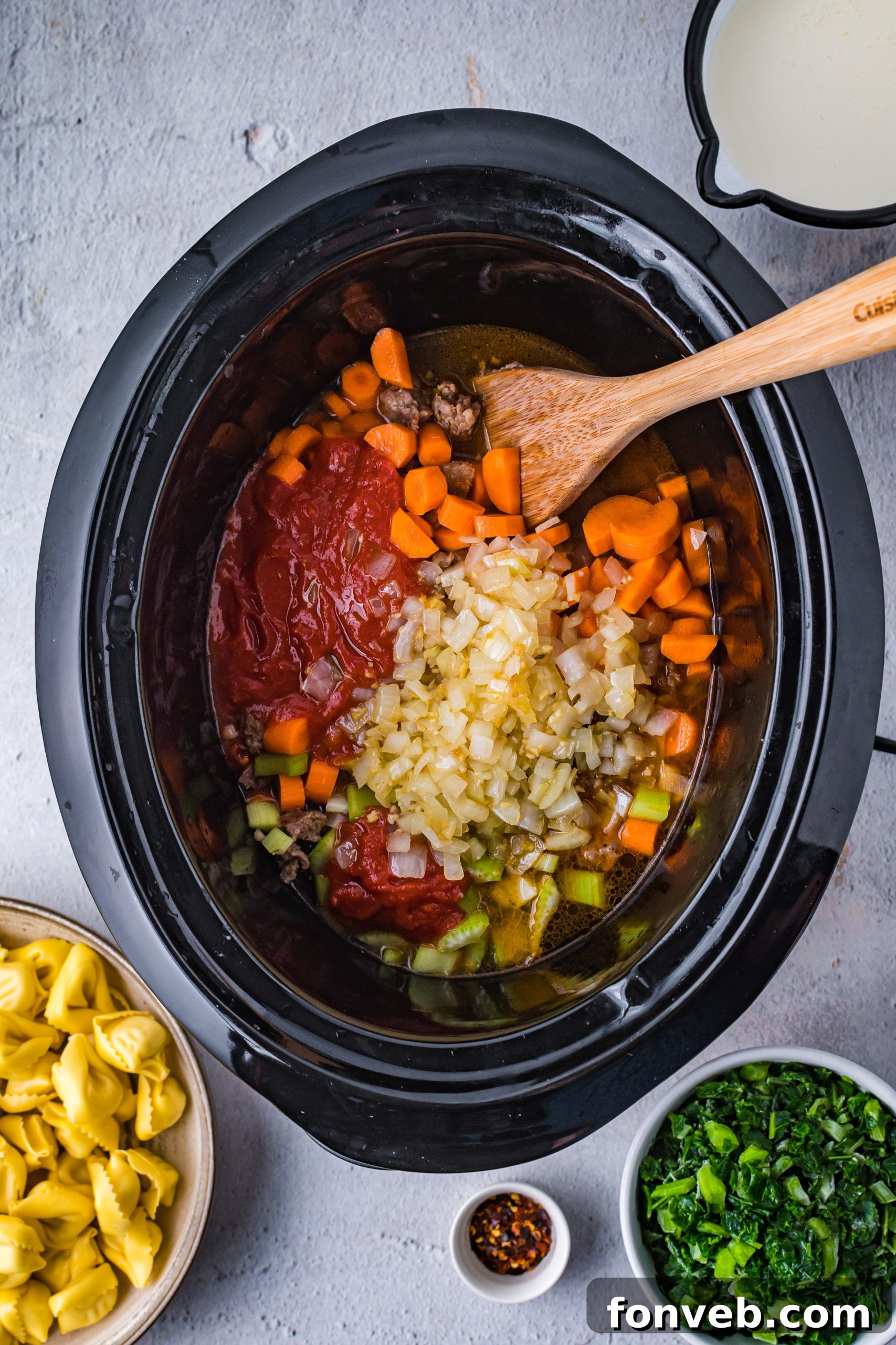 Overhead shot of Slow Cooker Creamy Tortellini Soup in a serving bowl