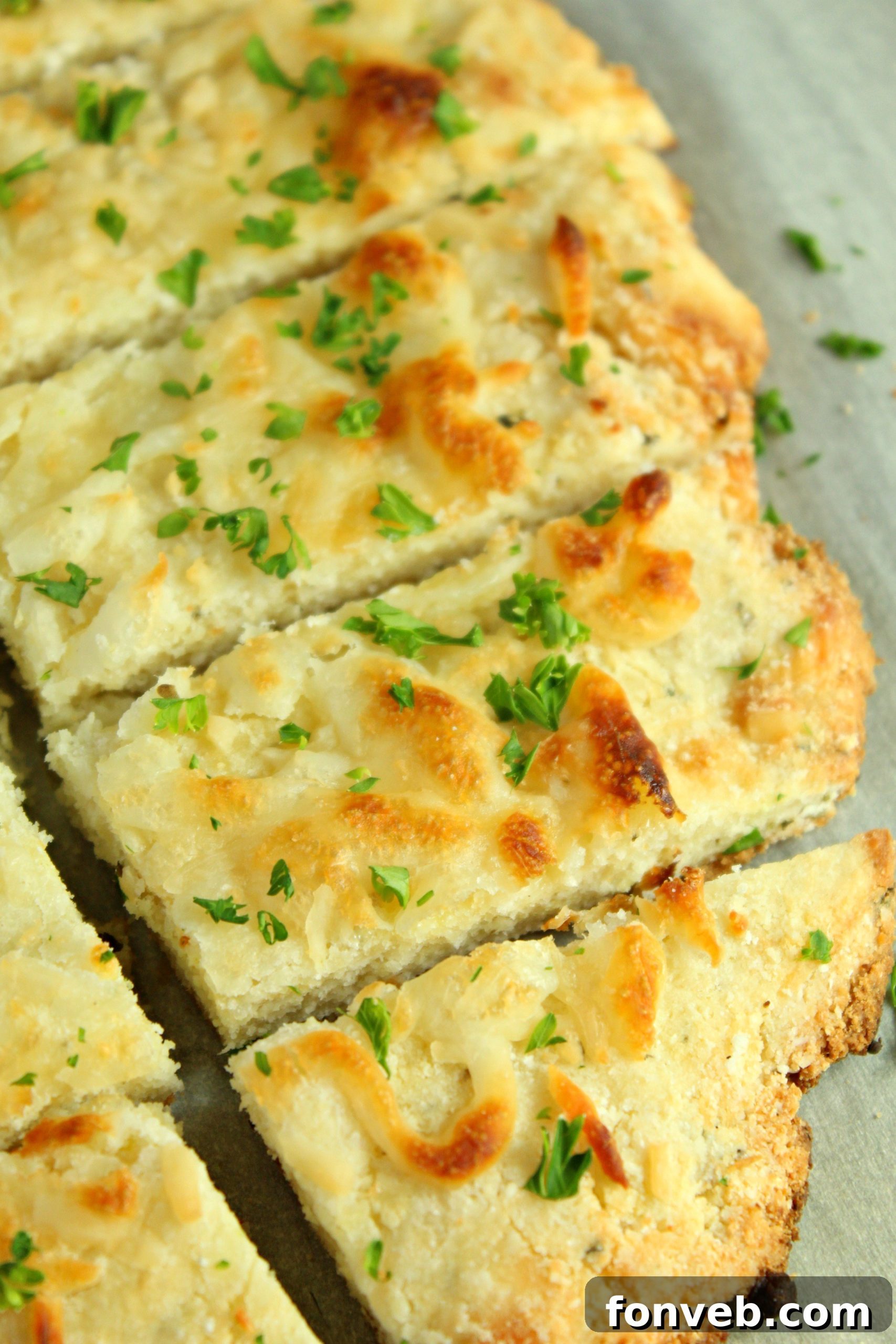 Delicious golden brown four cheese keto breadsticks on a baking sheet, ready to serve.