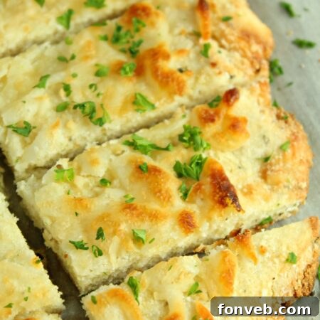 Close-up of freshly baked Four Cheese Keto Breadsticks with herbs.