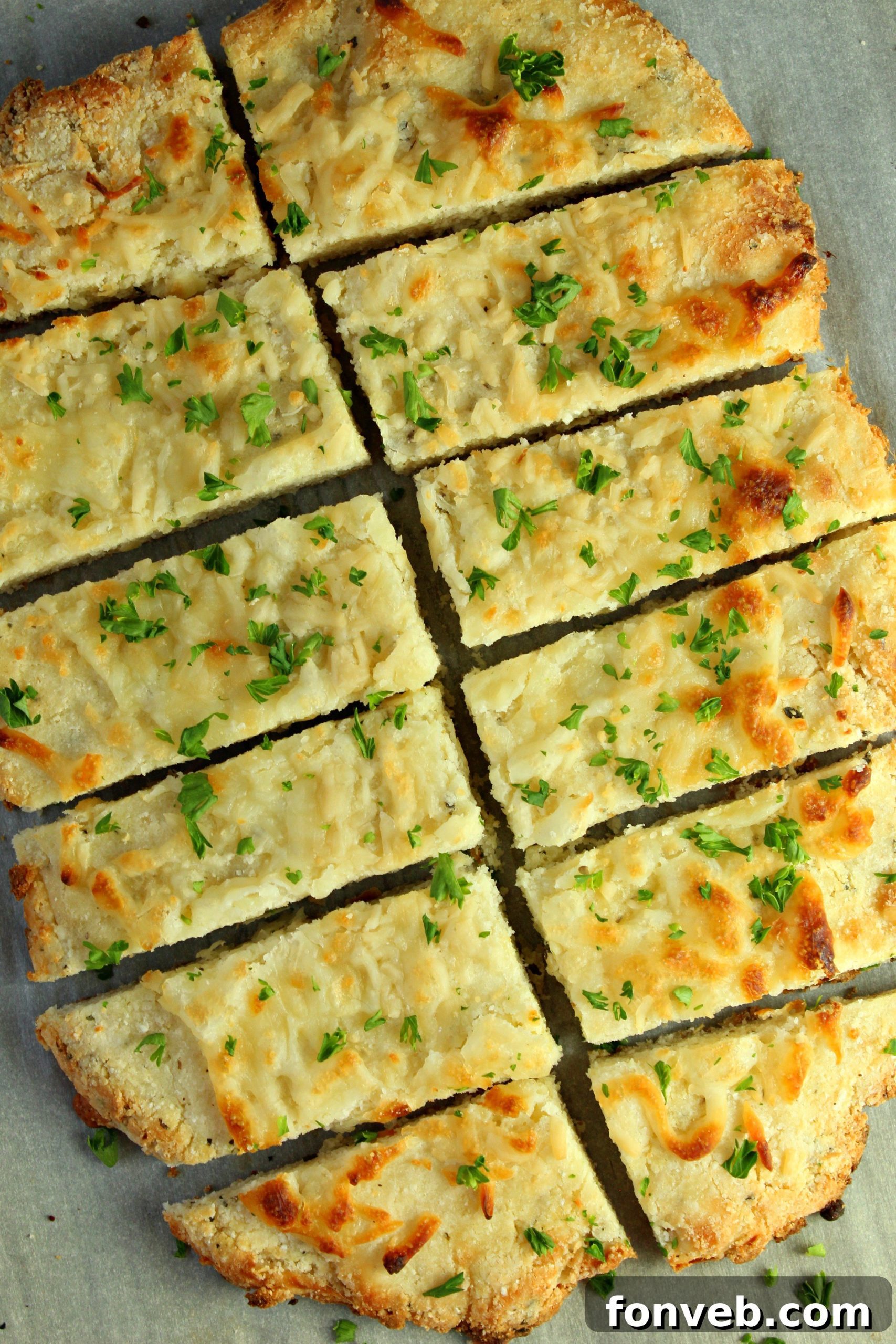Close-up shot of hot and cheesy keto breadsticks with visible melted cheese and herbs.