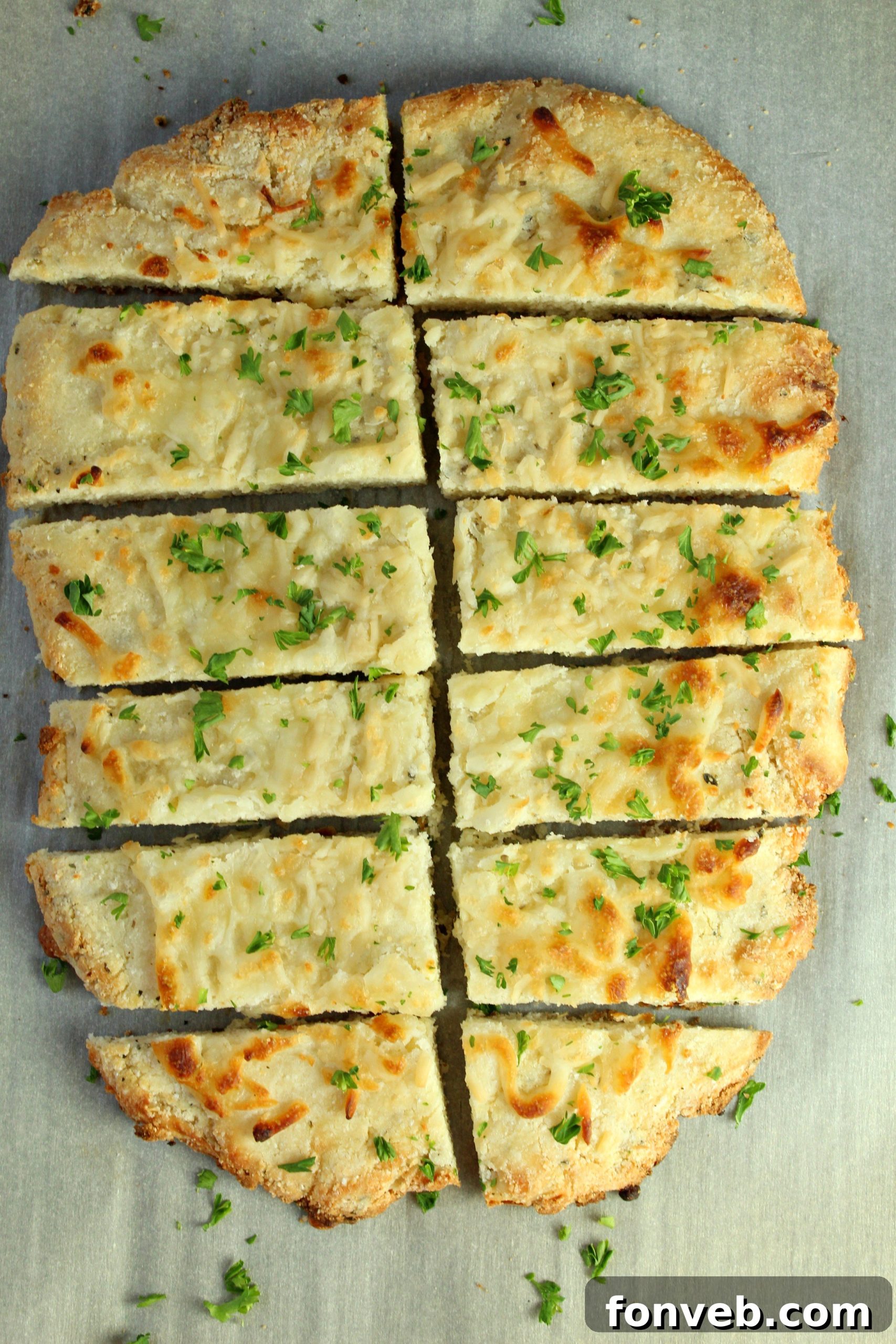 A close-up of a single keto breadstick, showing its cheesy, textured surface.