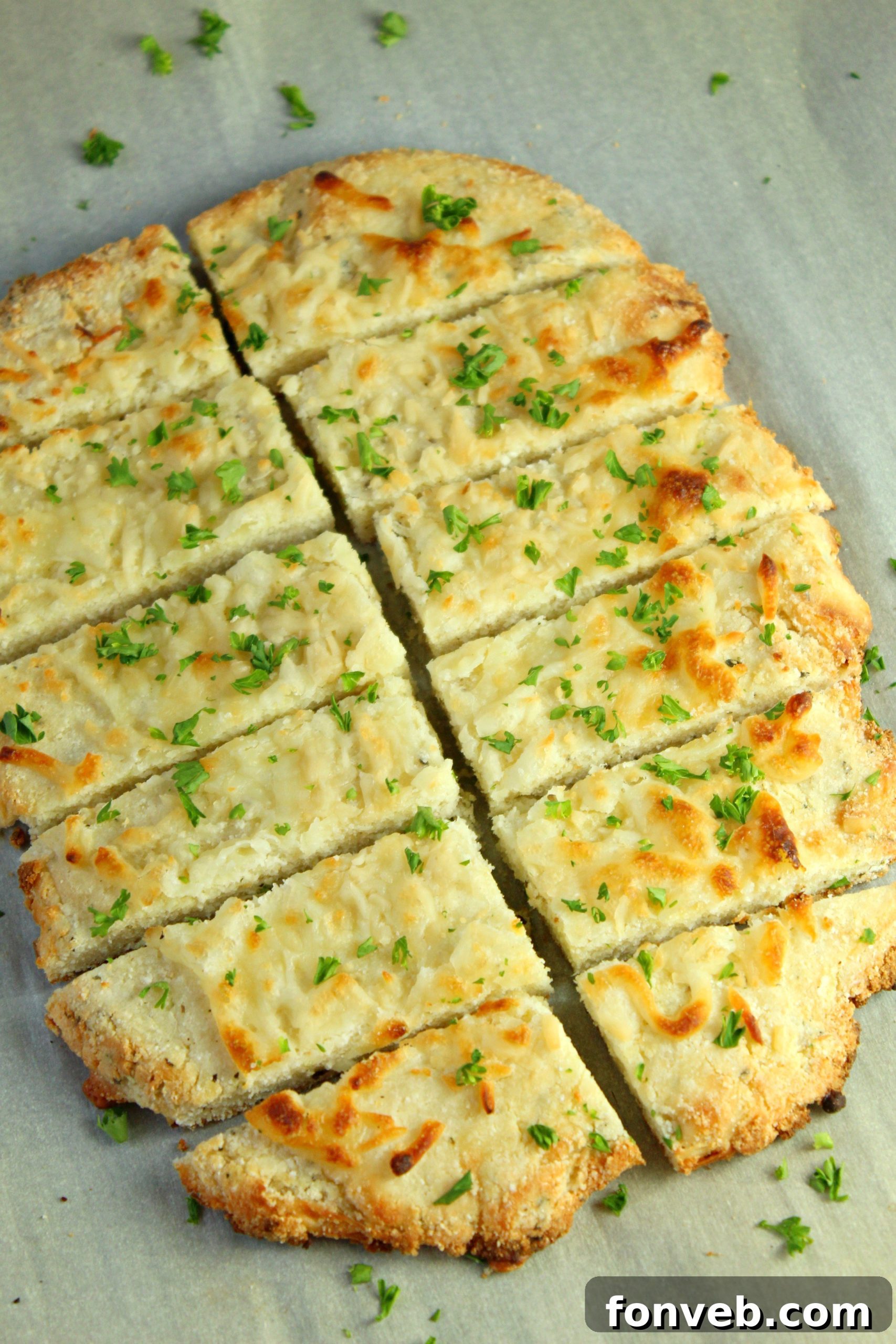 Ingredients for keto breadsticks laid out, including cheese, flours, and herbs.