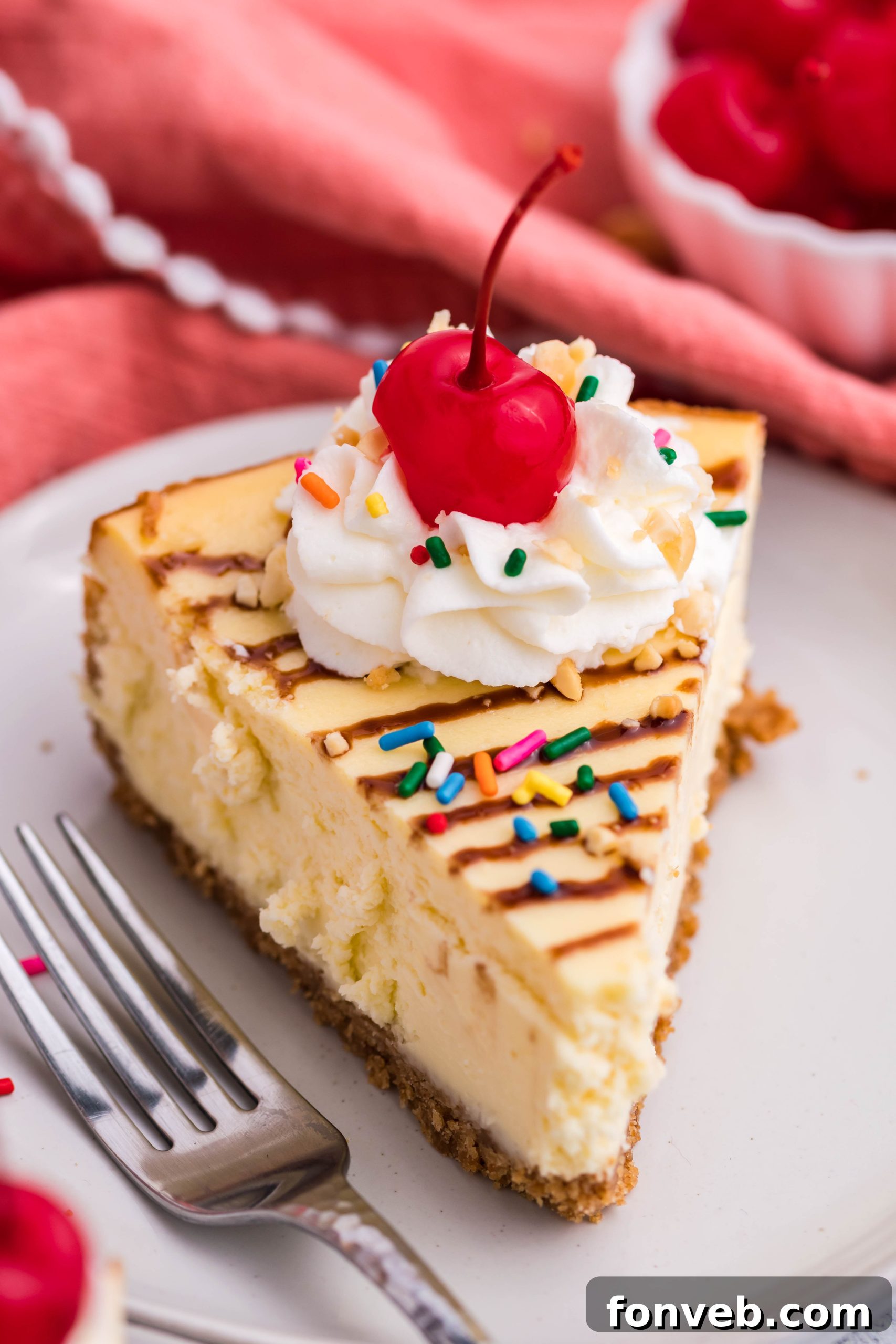 A close-up of the Banana Split Cheesecake, highlighting the rich, smooth texture of the banana-flavored cream cheese filling.