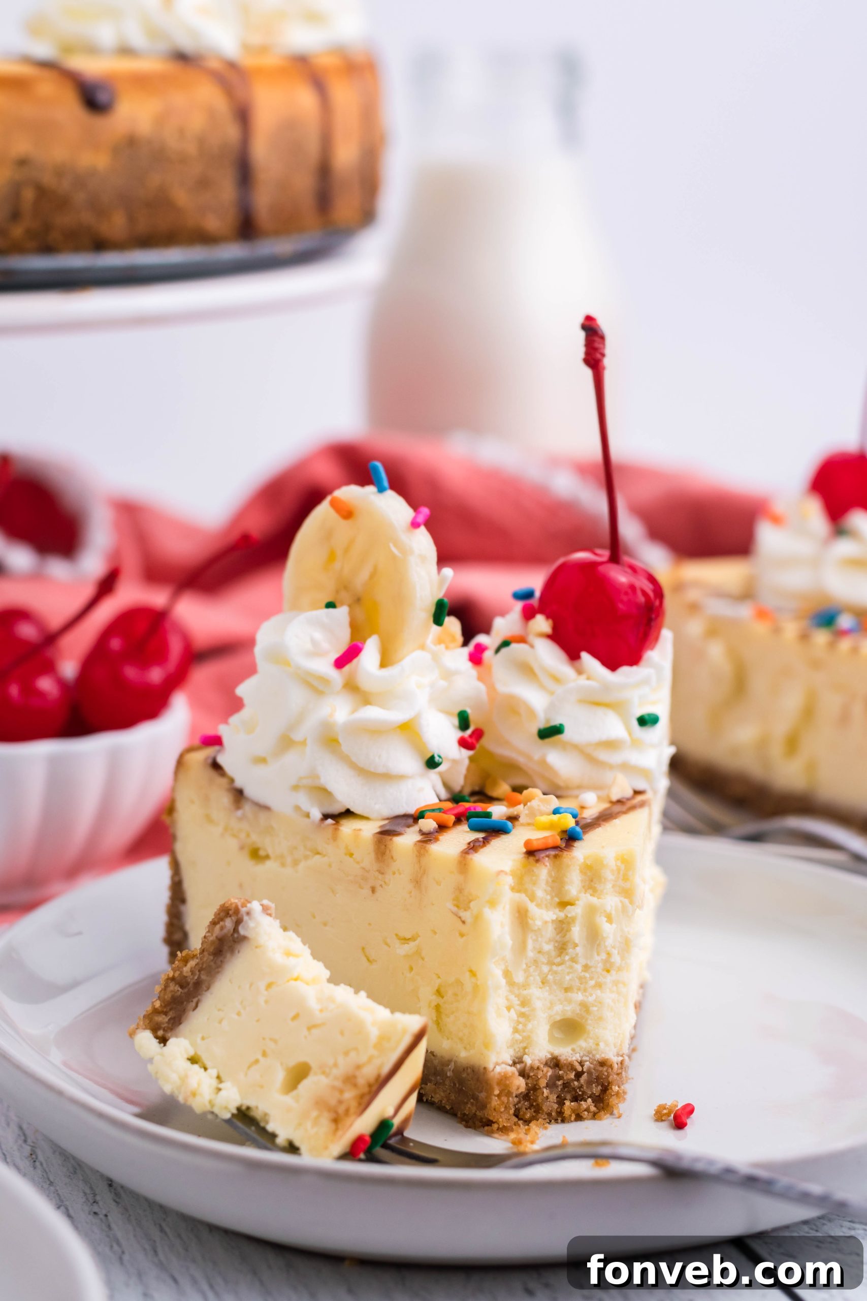 A close-up of the banana slices and maraschino cherries used as toppings for the cheesecake.