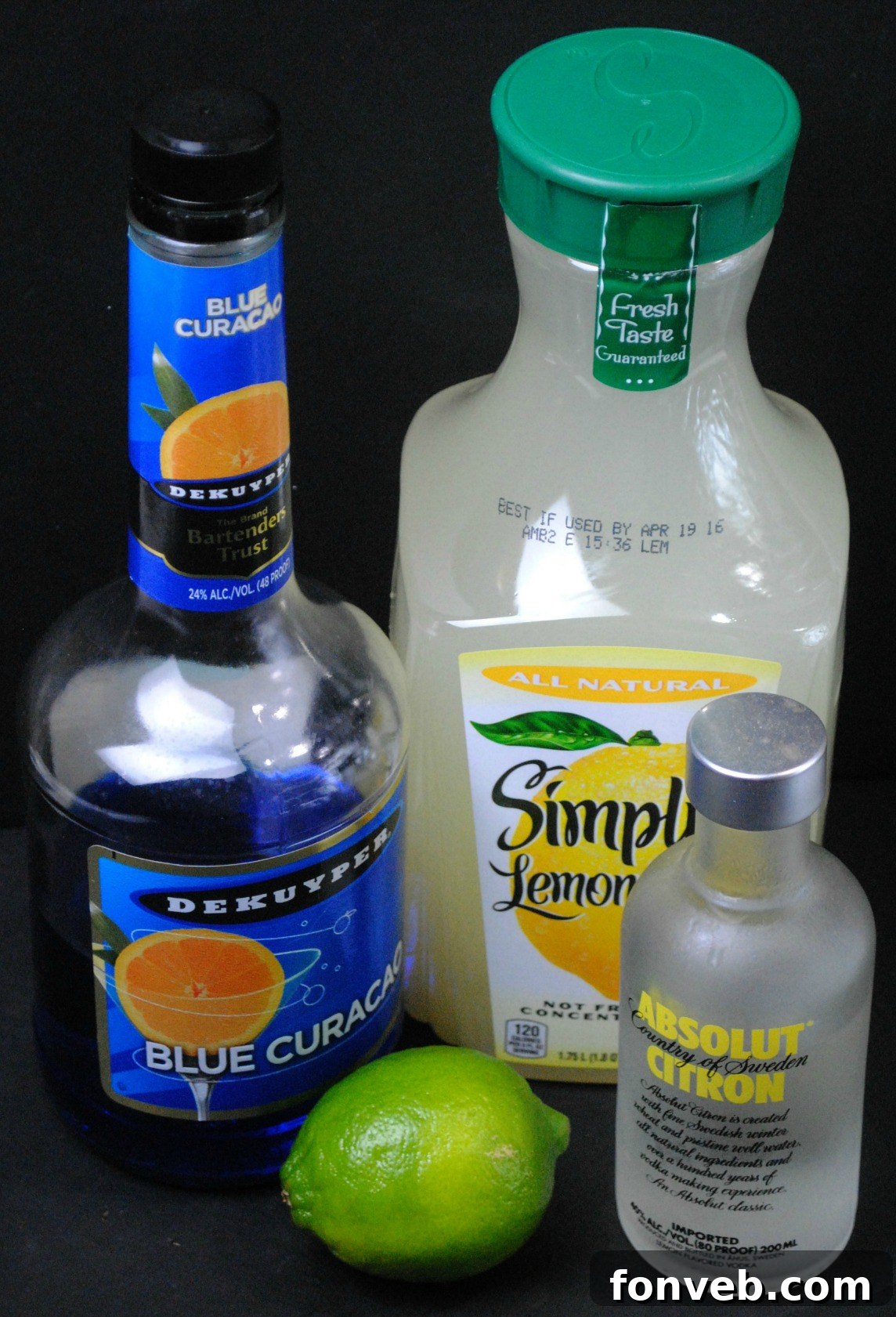 Close-up of a sparkling Electric Lemonade drink with abundant ice and a fresh lemon wedge, emphasizing its inviting and cool blue color