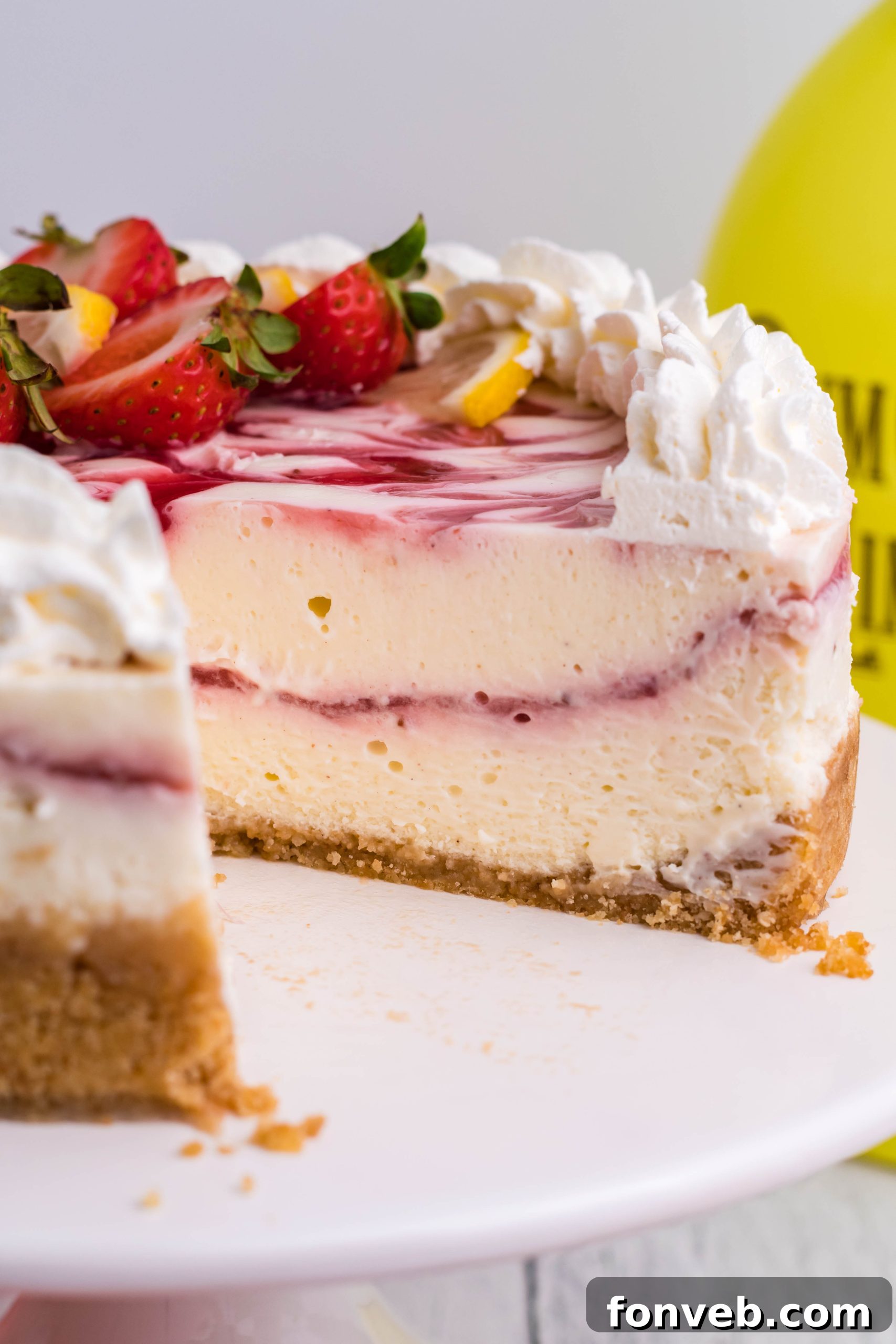 Close-up of the strawberry swirl within the creamy cheesecake, showcasing the texture.