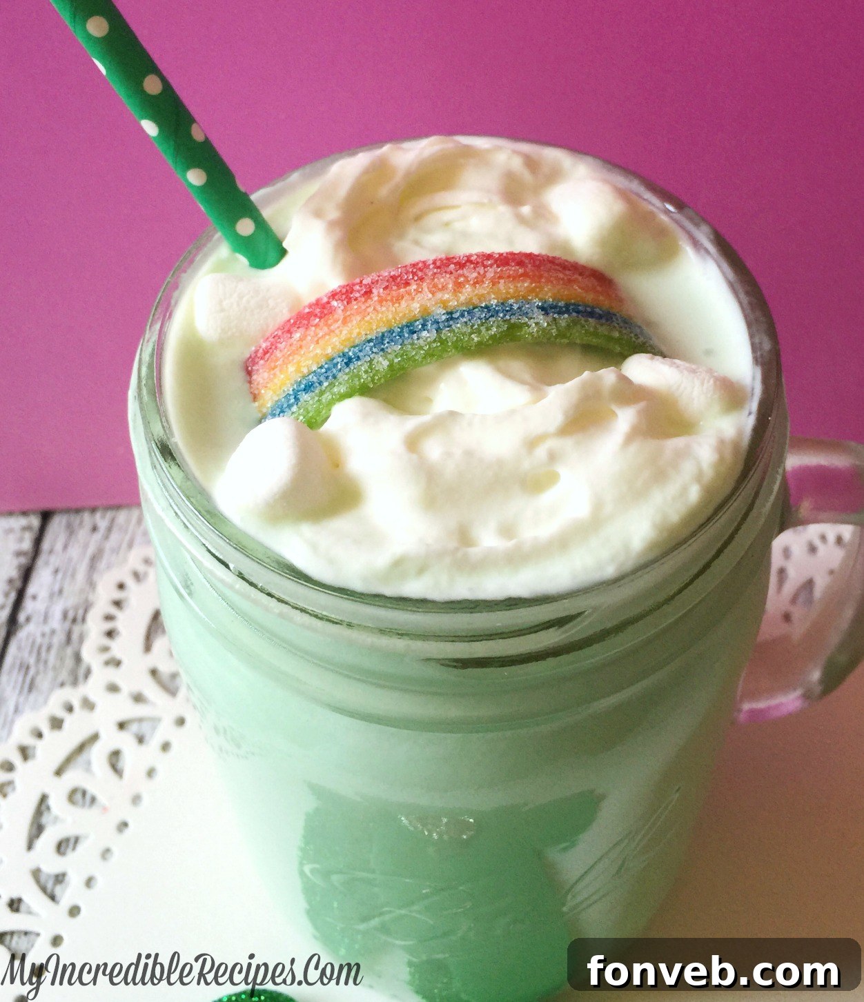 Delicious homemade Shamrock Cocoa topped with whipped cream and sprinkles, served in a clear glass