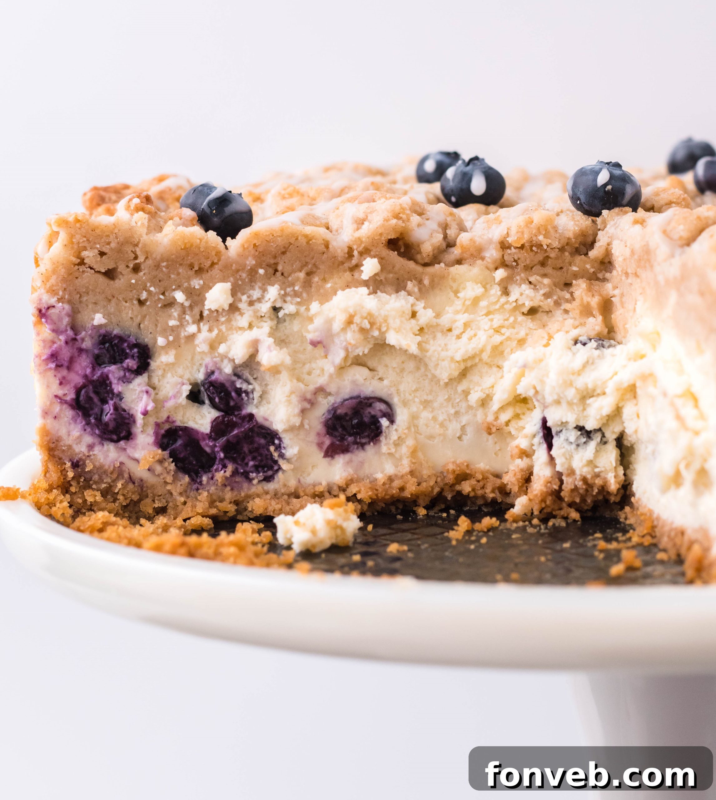 Blueberry Coffee Cake Cheesecake with a scoop removed