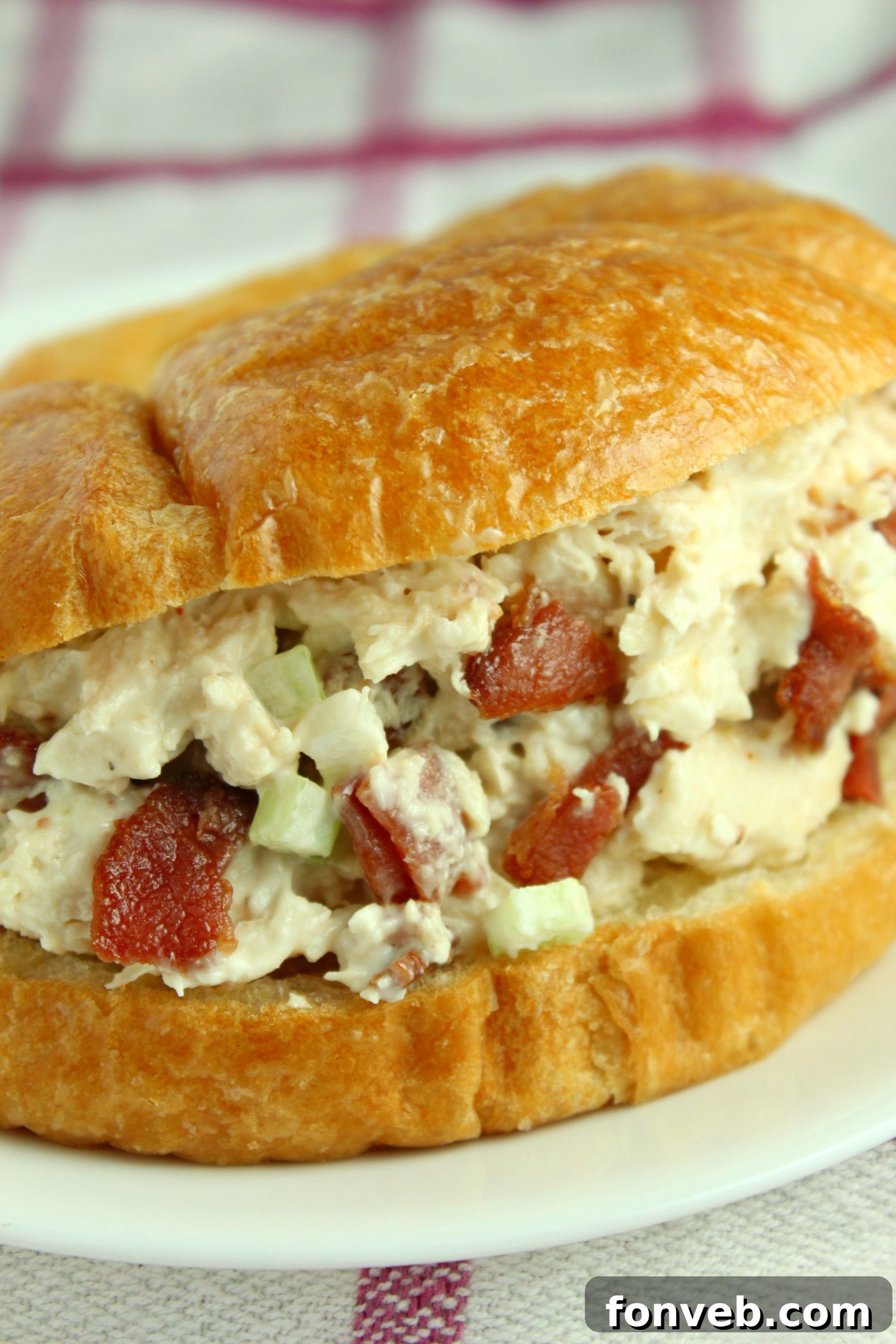 Homemade Willow Tree Bacon Chicken Salad 11 A fork taking a bite of Willow Tree Chicken Salad from a bowl