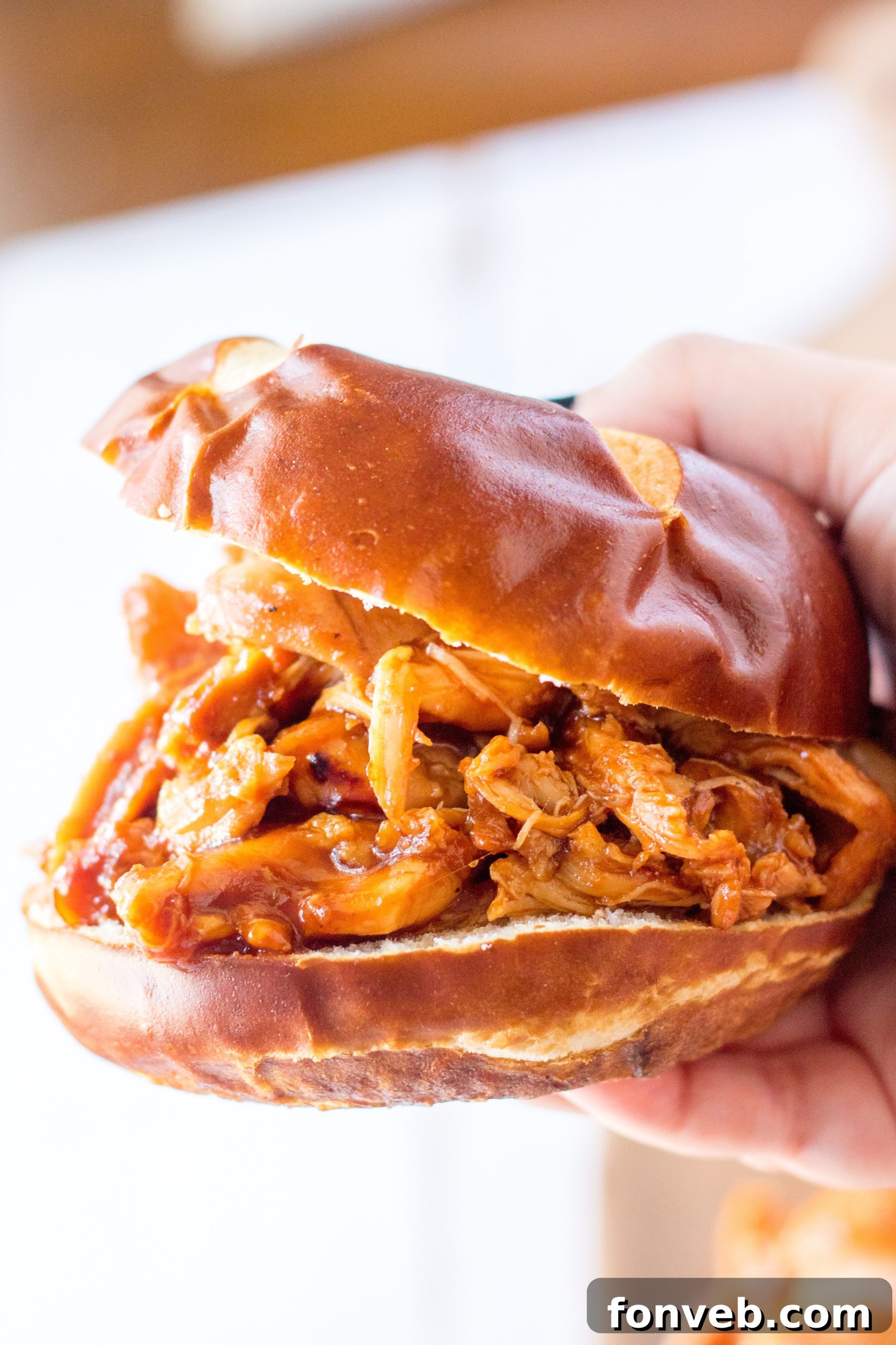 Cooked Slow Cooker Root Beer Chicken being pulled apart with forks